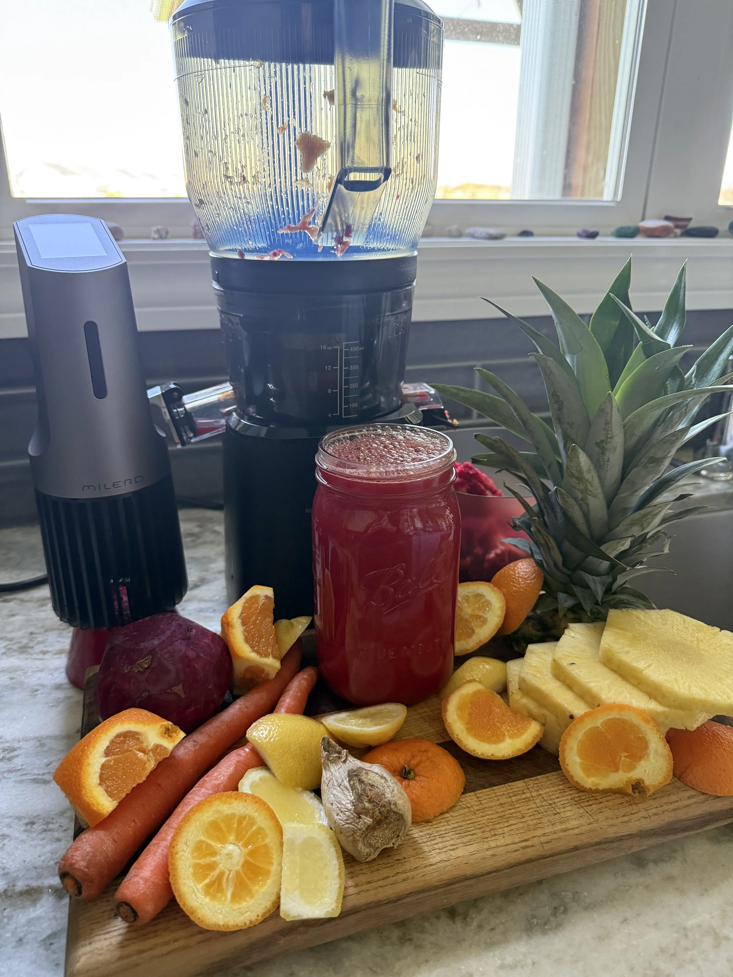 Fresh hormone-balancing juice made with carrots, beet, oranges, lemons, pineapple, and ginger to support estrogen balance during perimenopause.