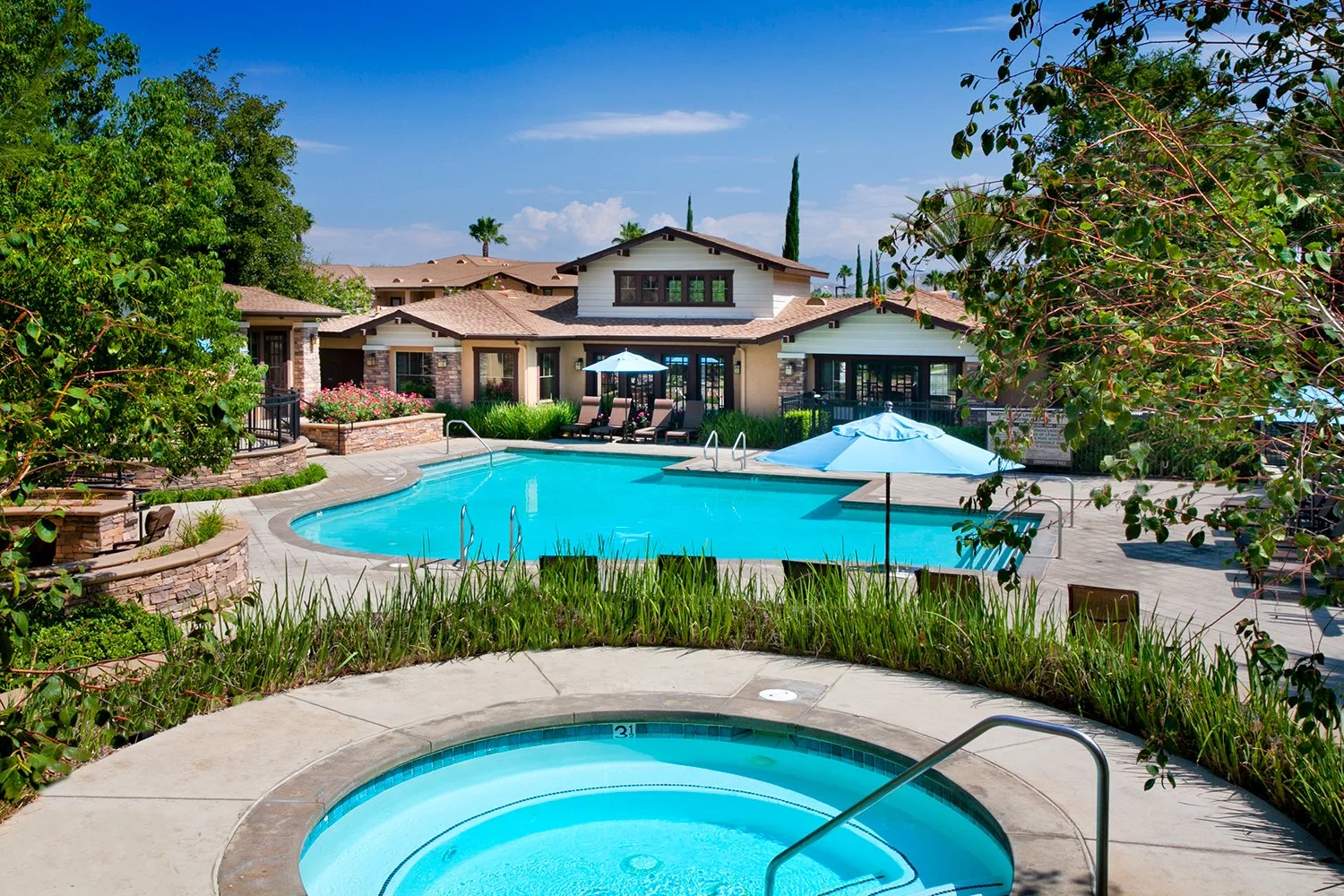 Overlook Pool Area with gorgeous resort style pool and luxurious relaxing spa overlooking the mountain ranges and blue sky