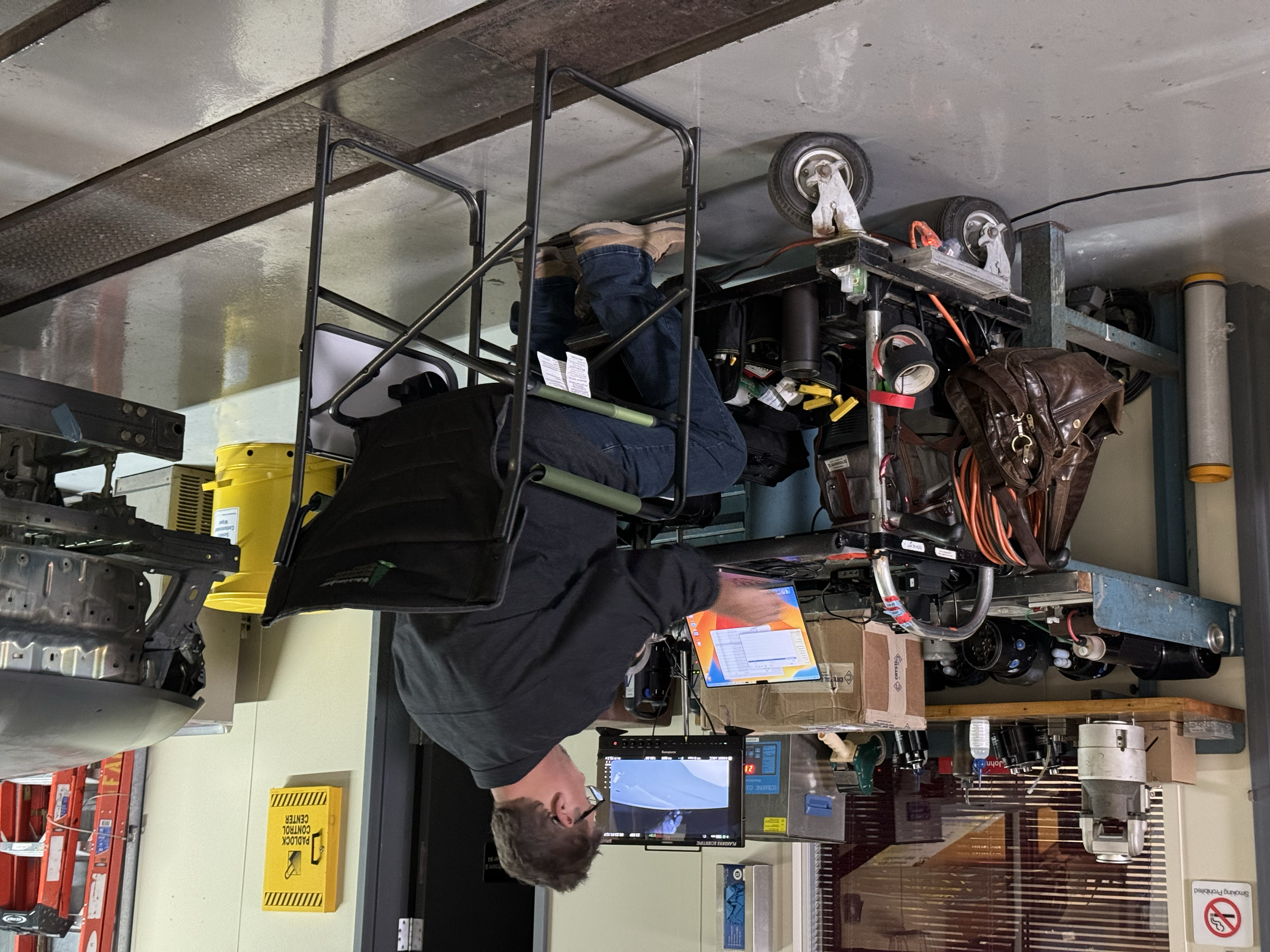 Best Buy employee at checkout counter using a computer with equipment around in an electronics store.