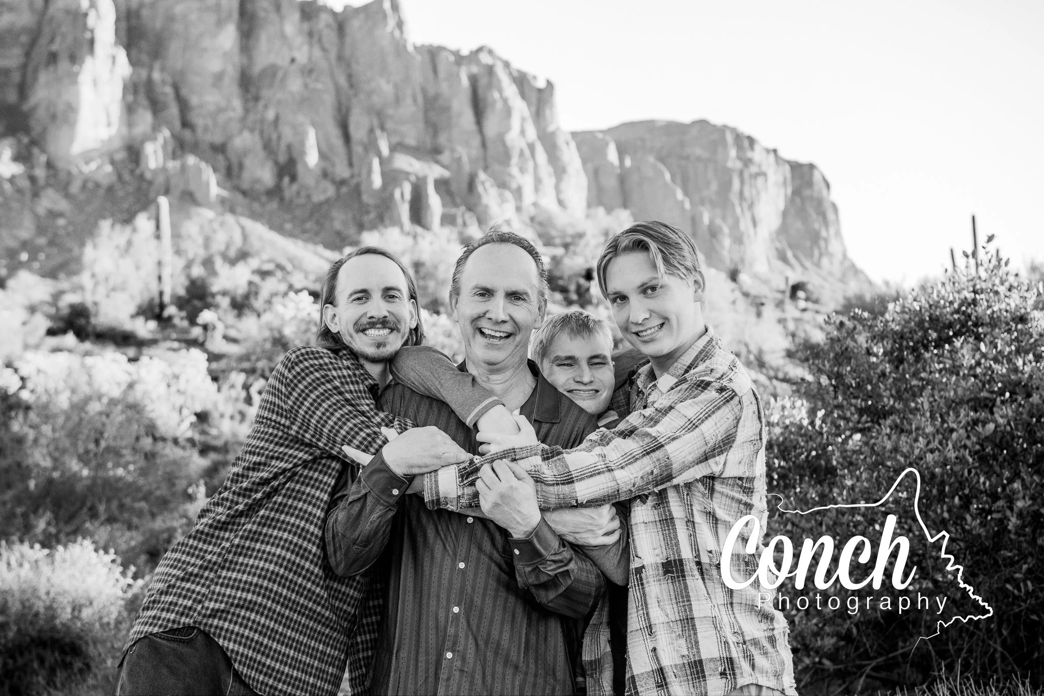 Black and White group hug with Dad and Sons at First Water Trailhead