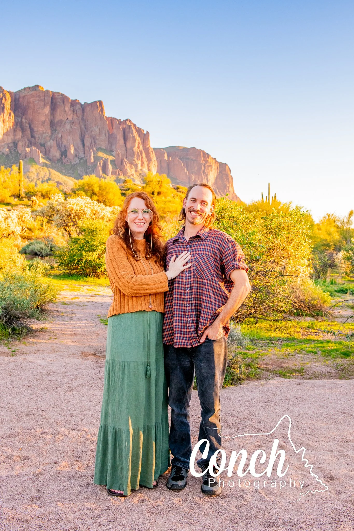 Full body image of a couple at sunset at First Water Trailhead
