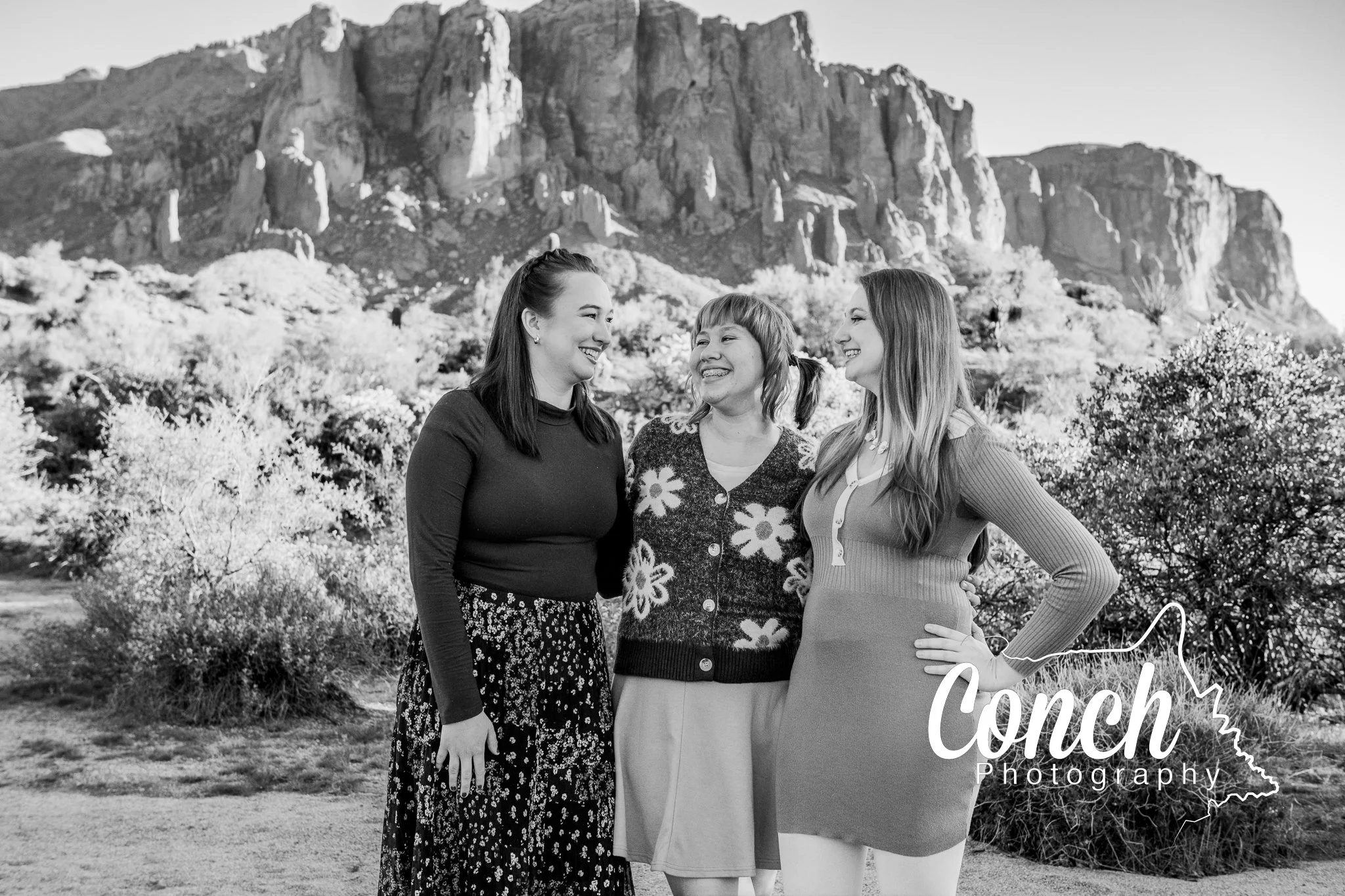 Close up black and white image of 3 sisters laughing at First Water Trailhead