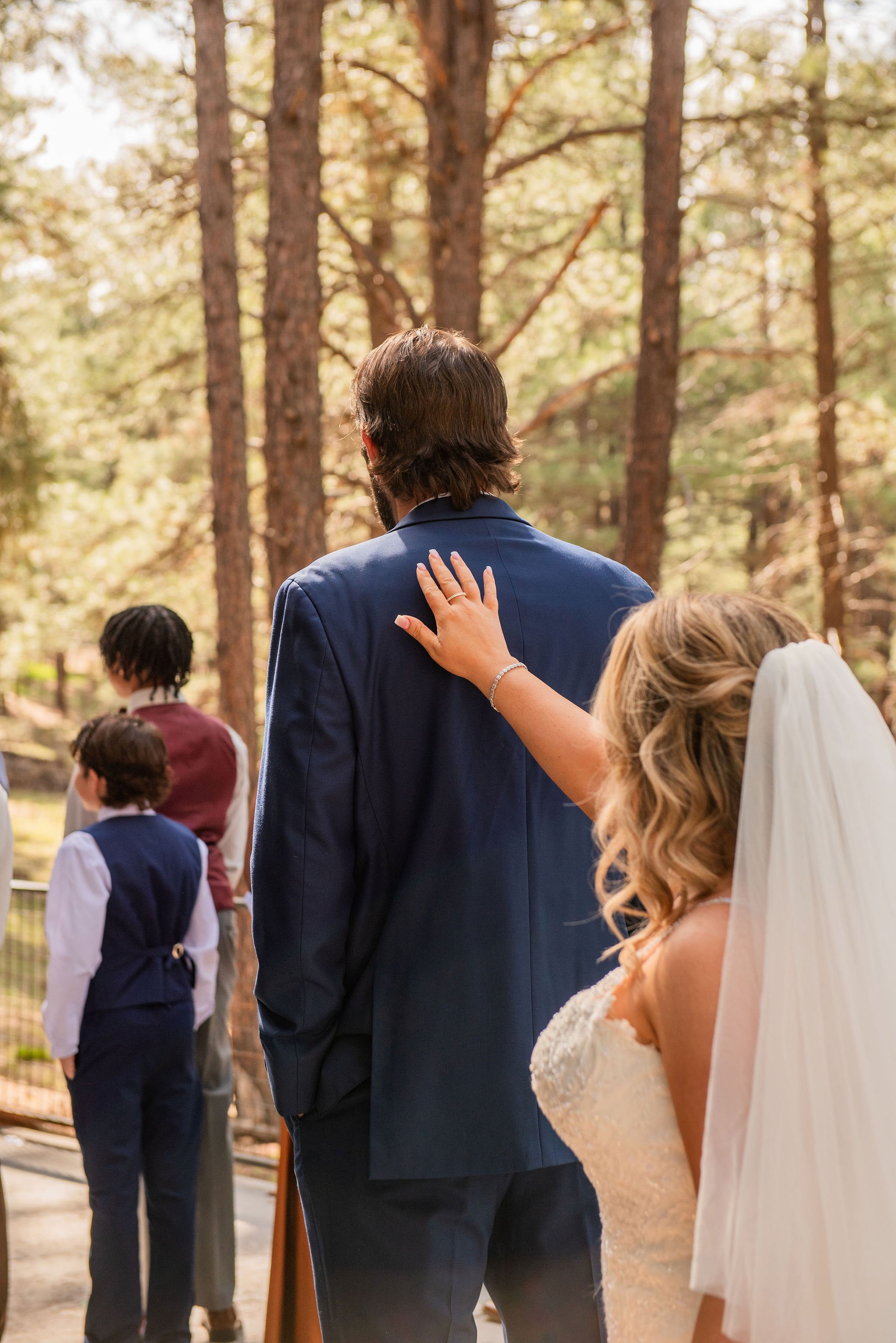 Bride taps grooms shoulder during the first look in Flagstaff, Arizona
