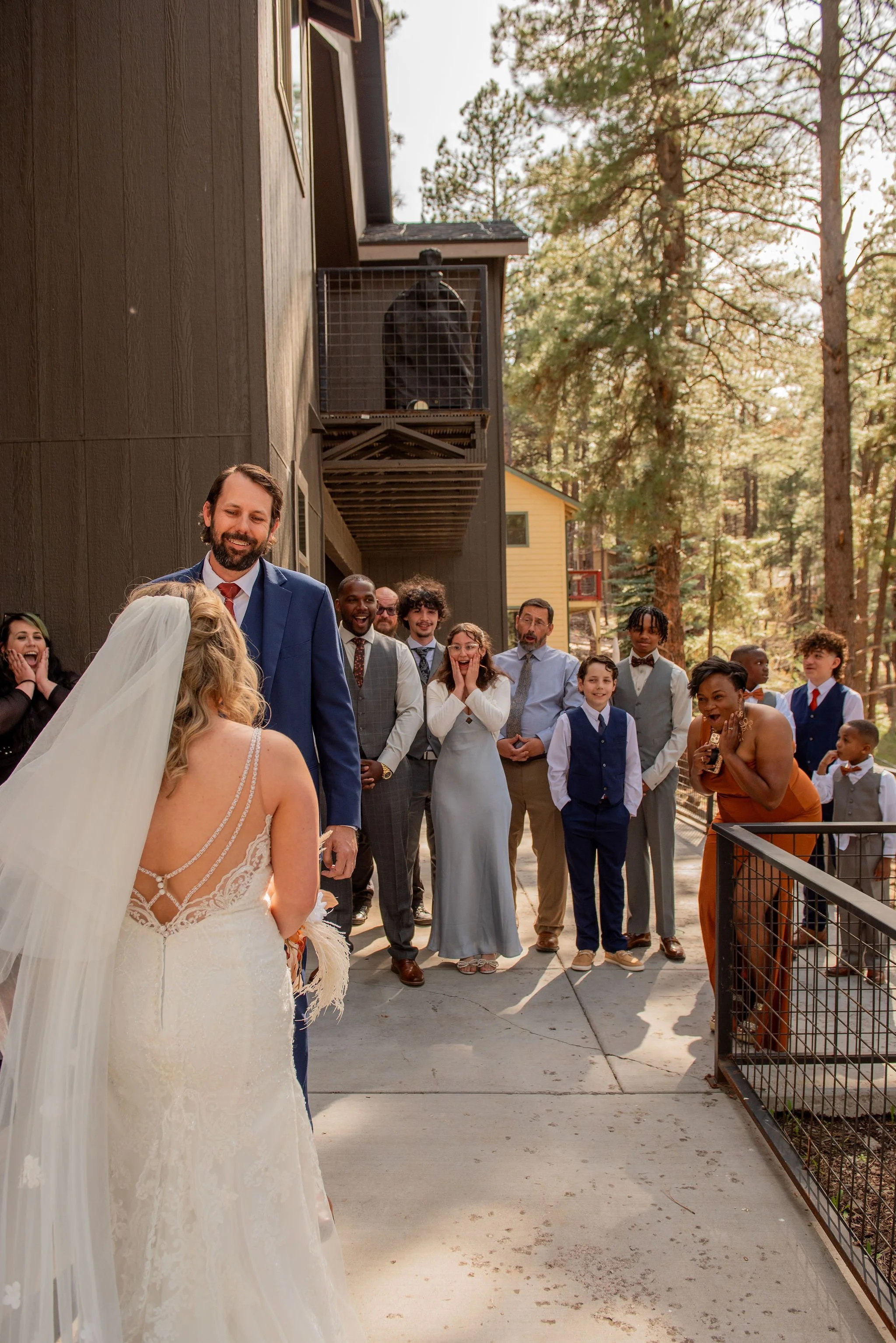 The groom, and guests, see the bride for the first time during the couples first look in Flagstaff, Arizona