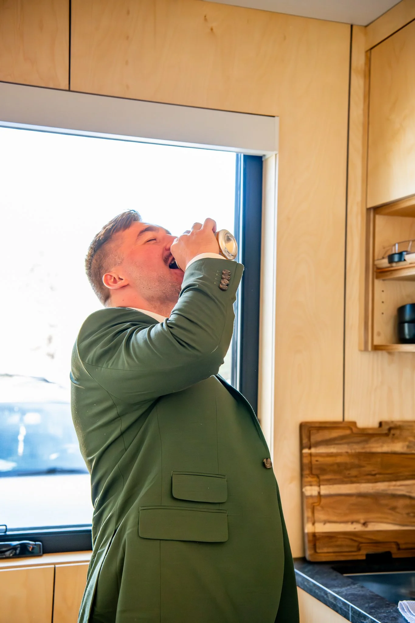 Groom sneaks a drink before the couples destination adventure elopement in Prescott, Arizona.