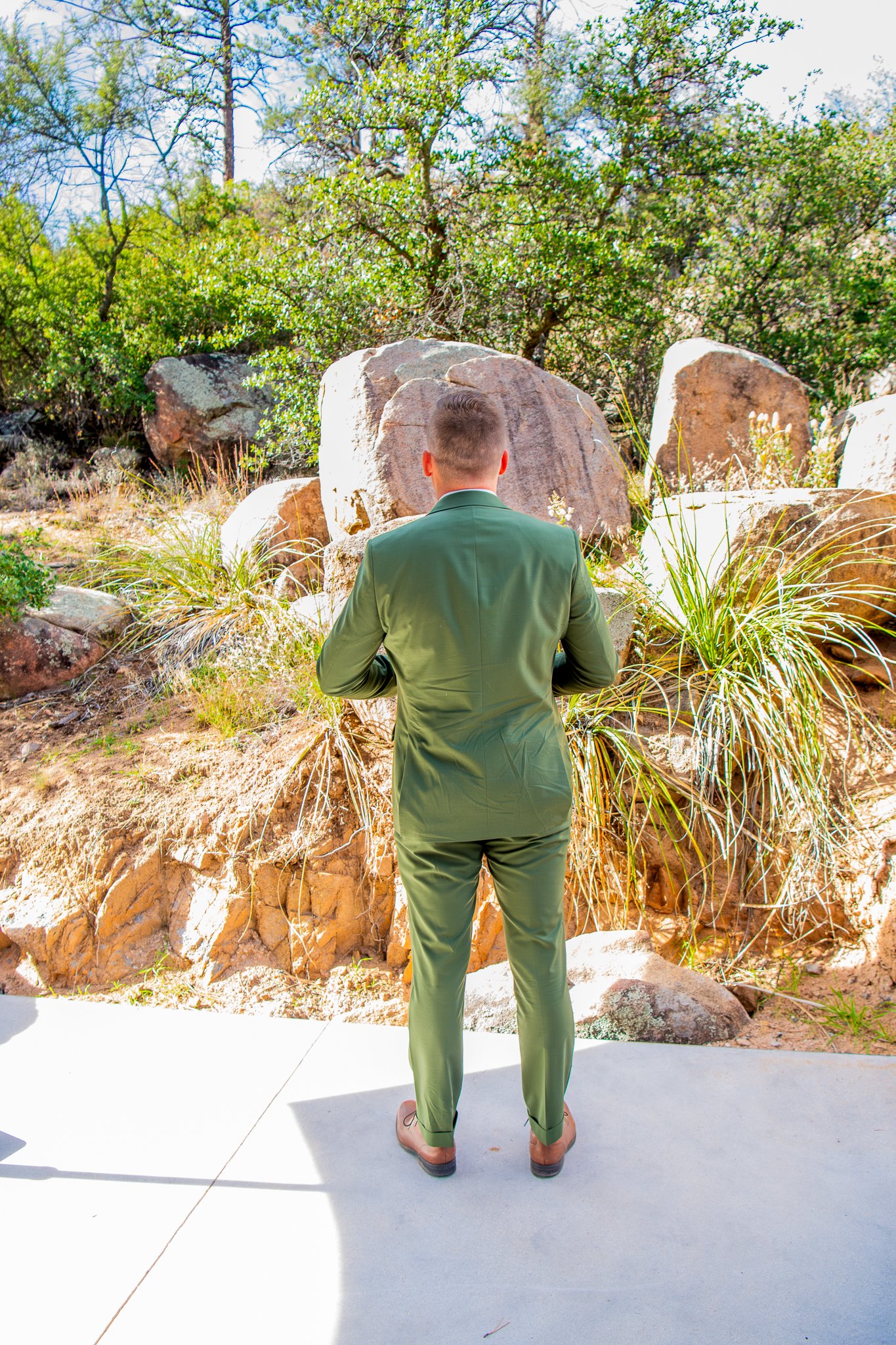 Image of the Grooms backside as he waits for the first look to begin during destination adventure elopement in Prescott, Arizona