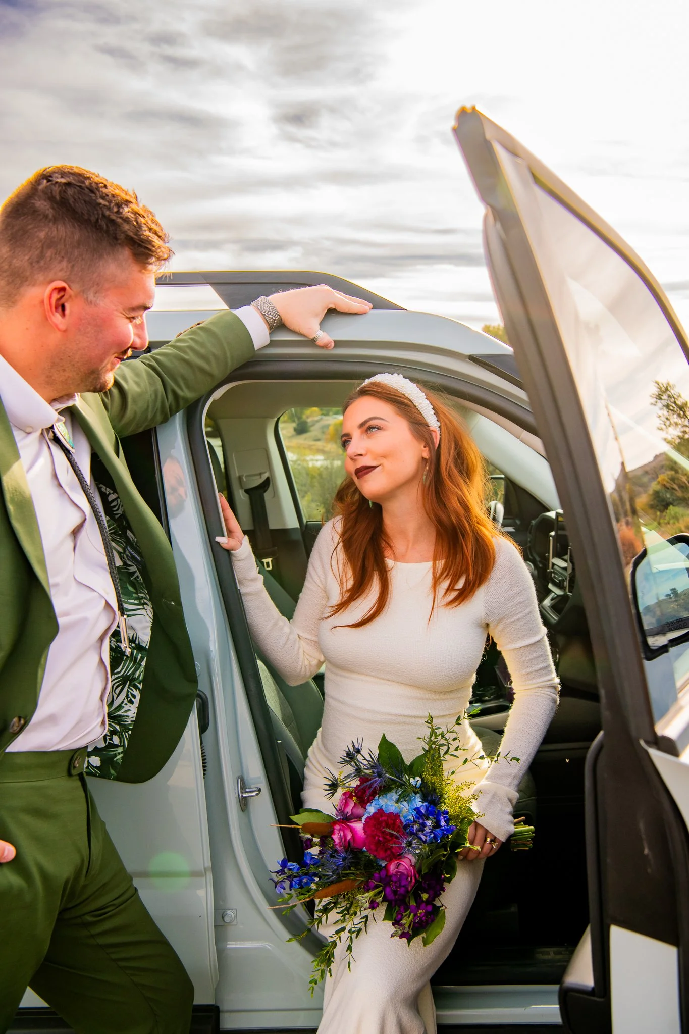 Close up portrait image of groom opening the door of their rented Ford Bronco for his bride at Watson Lake in Prescott, Arizona during their destination adventure elopement.