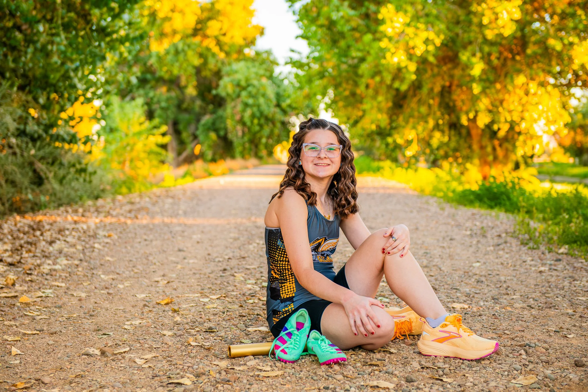 Gilbert Senior Graduate poses with her track gear during a golden hour sunset at the Riparian on Higley and Ocotillo in Gilbert, Arizona