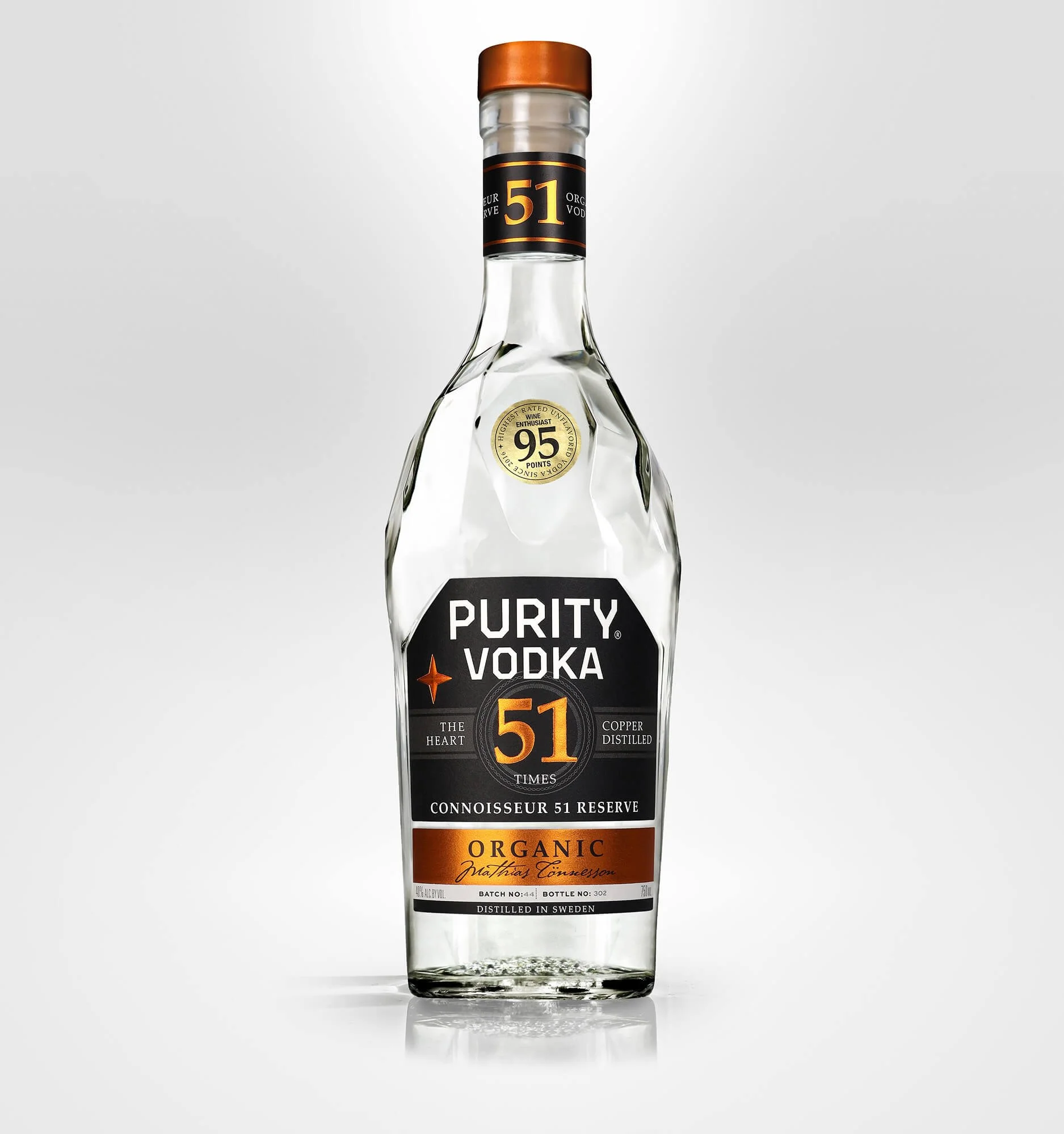 A clear glass bottle of Purity Vodka with black, orange, and gold label, featuring the number 51, placed against a plain white background.