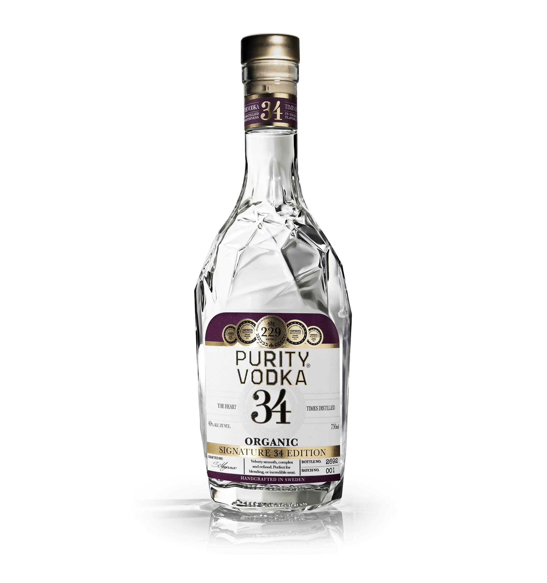 A clear glass bottle of Purity Vodka with a purple, gold, and white label, sitting on a reflective surface, against a black background.
