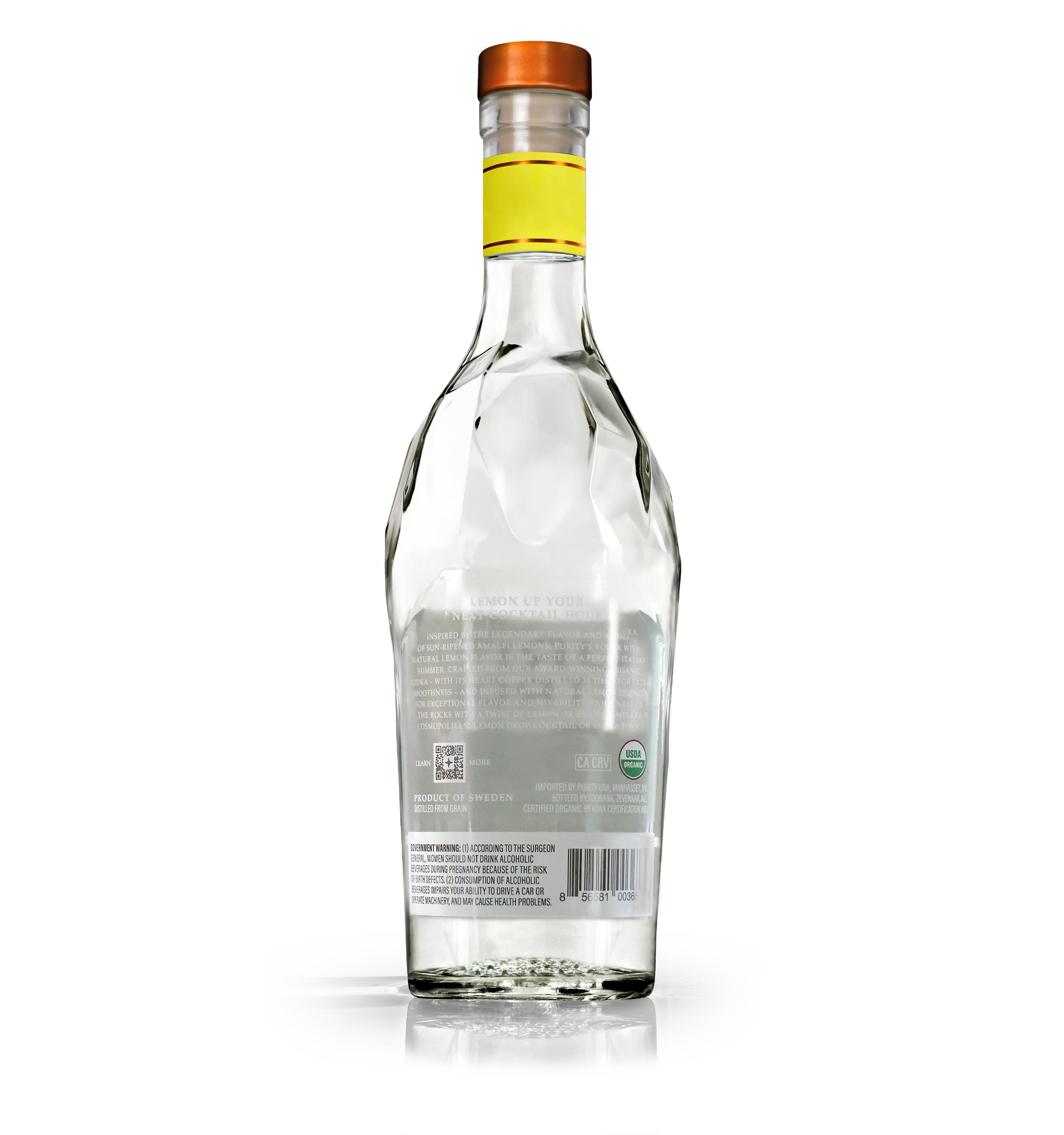 Clear glass bottle with a metal cap, yellow label, and back label containing text, standing on a reflective surface.