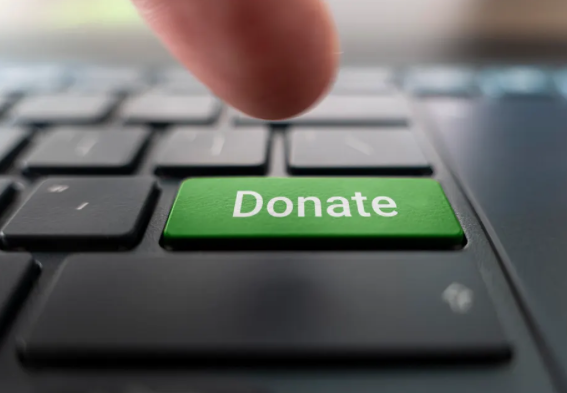 Green donate button on the keyboard close-up. blurred UHNW Families consider donations in light new tax benefits from 2025 One Big Beautiful Bill Act