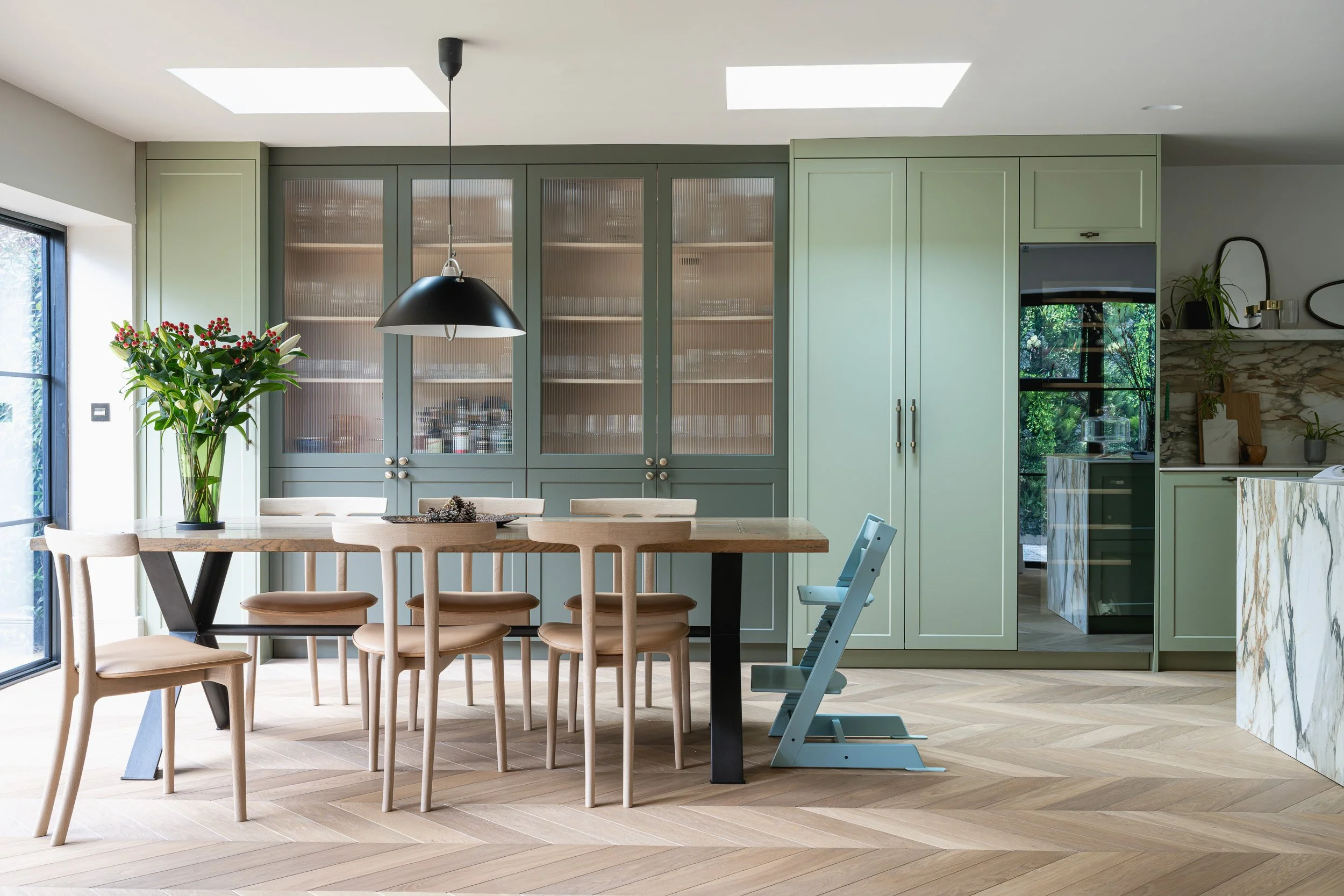 Open-plan kitchen and dining space with garden-facing windows