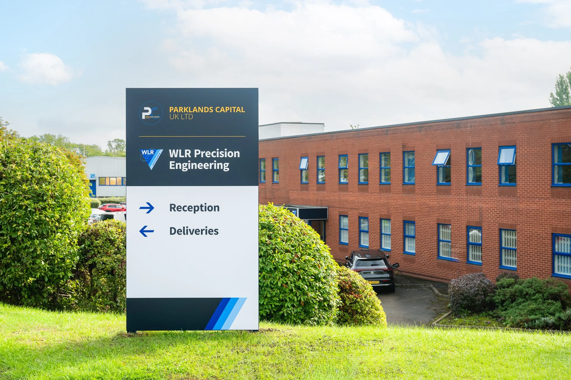 WLR Precision Engineering and Parklands Capital sign outside a red-brick business premises.