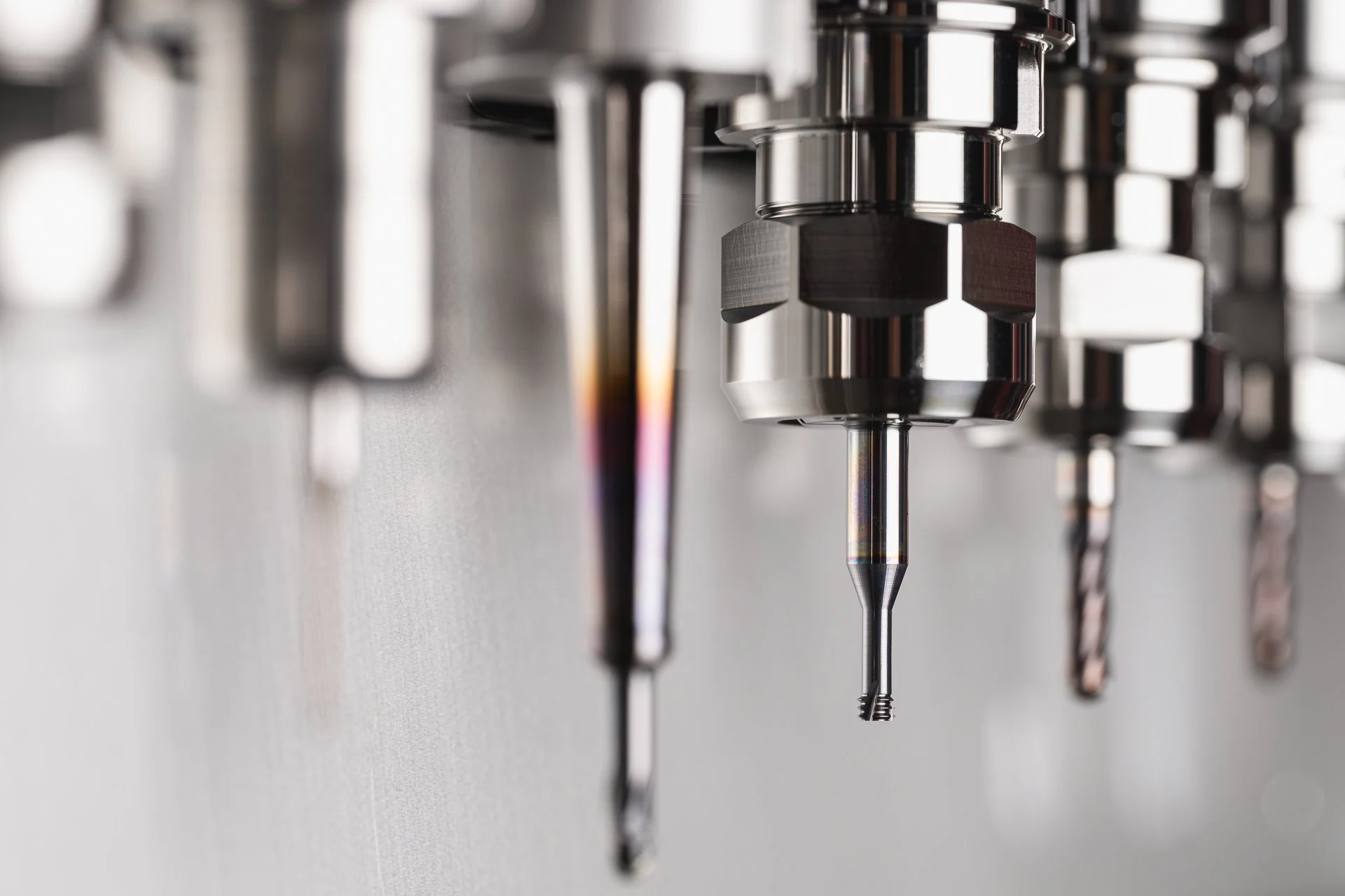 Close-up of machining tools arranged in a row, with the background softly out of focus.