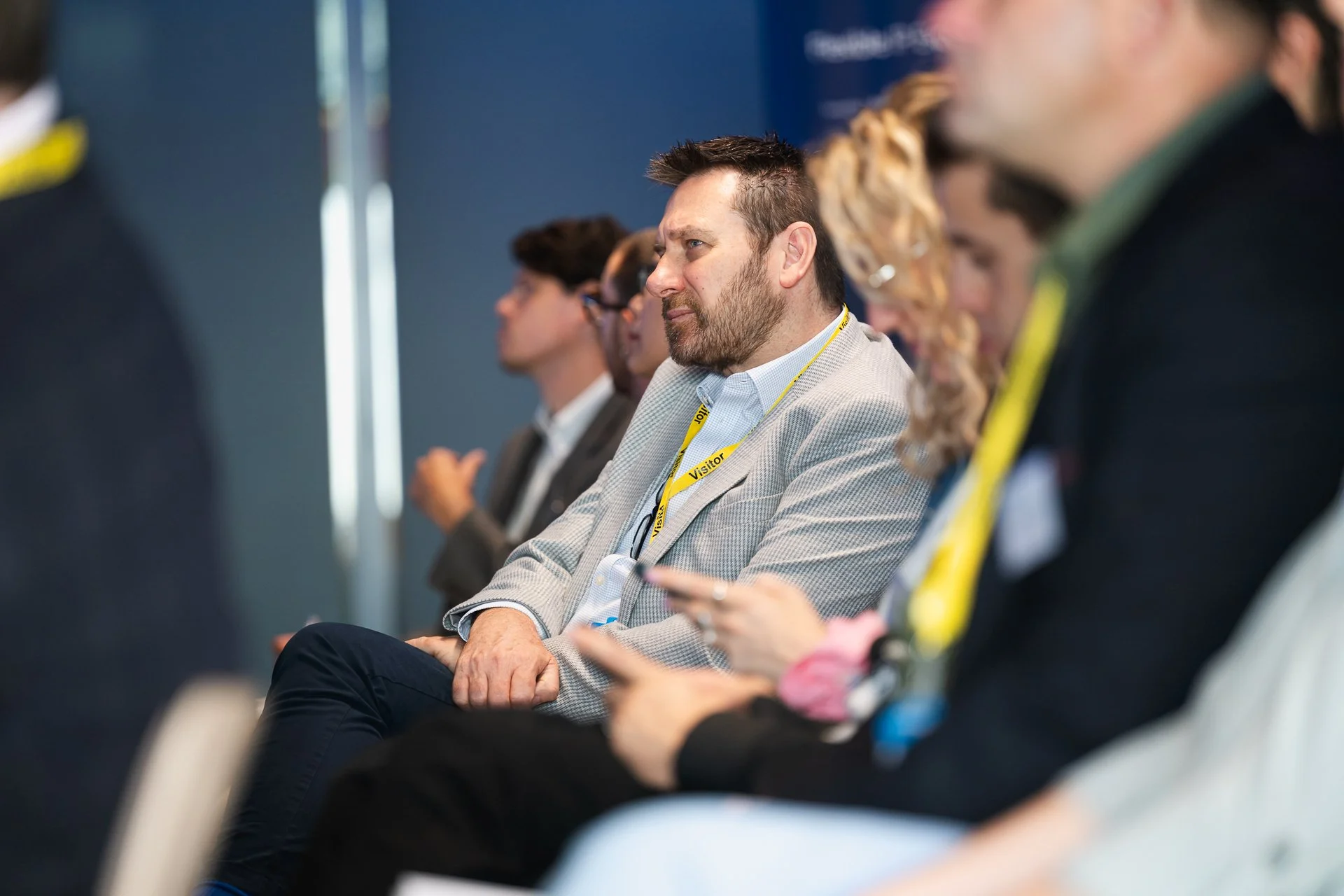 A row of seated delegates listening during a conference session.