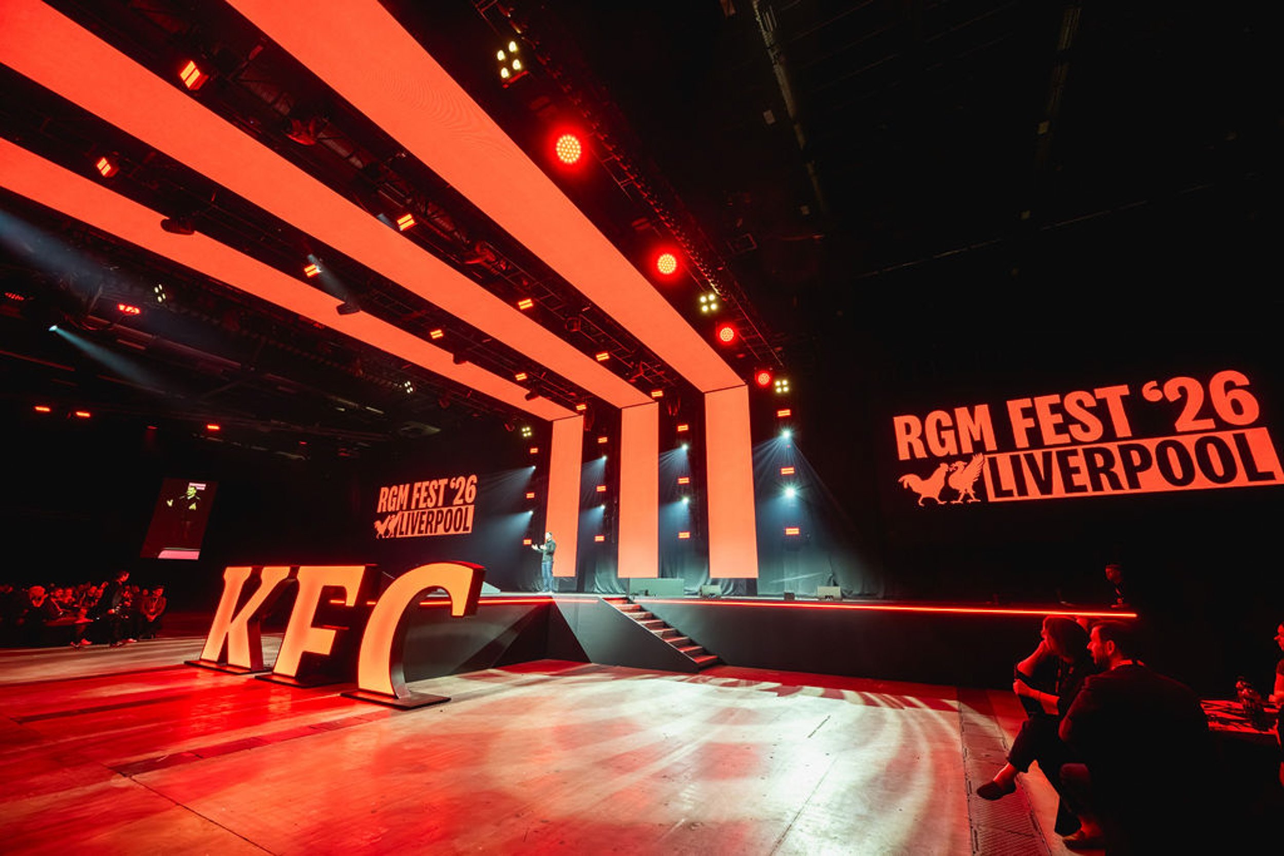 Large KFC lettering beside the red conference stage.