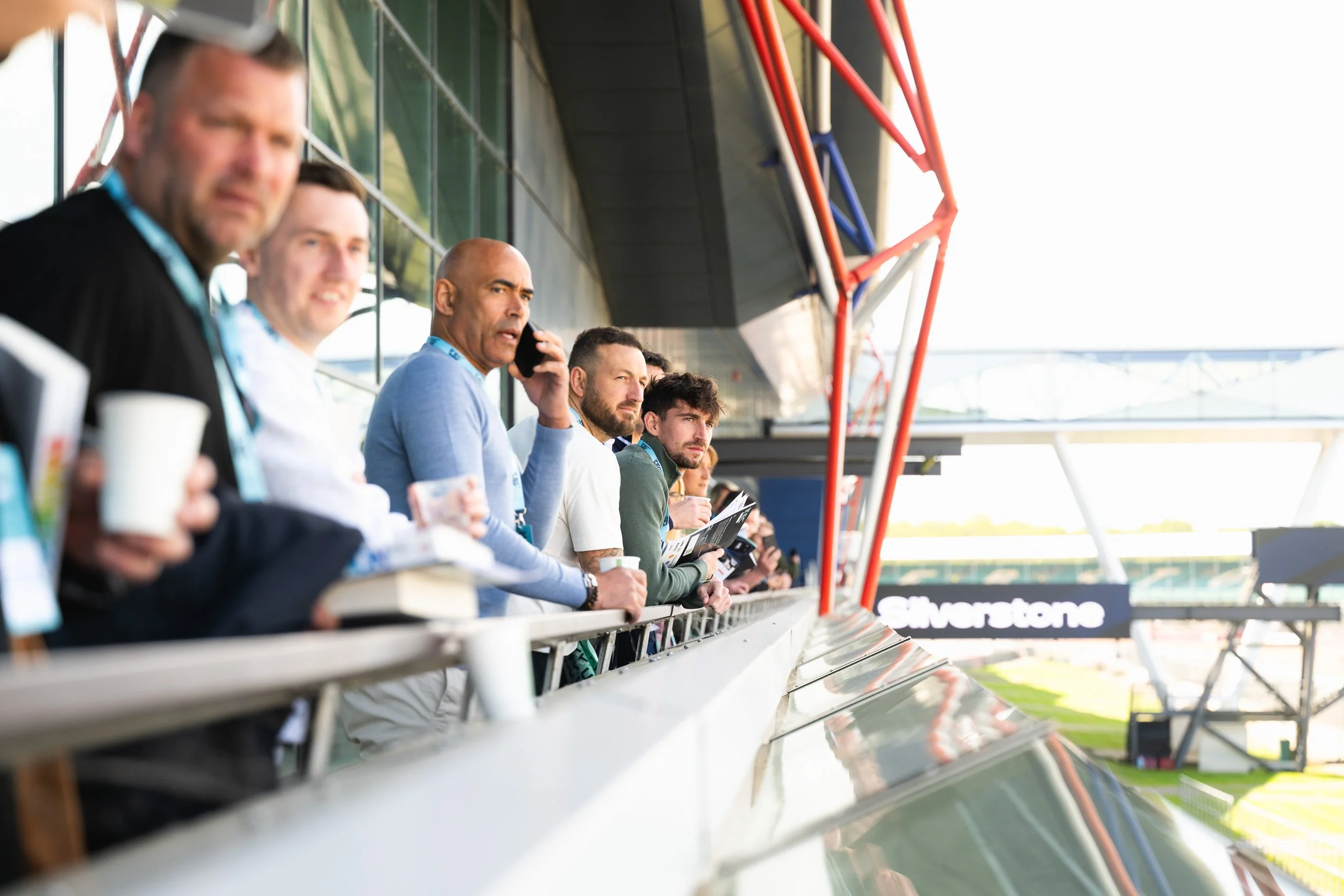 Delegates gathered along a balcony overlooking the Silverstone pit lane.