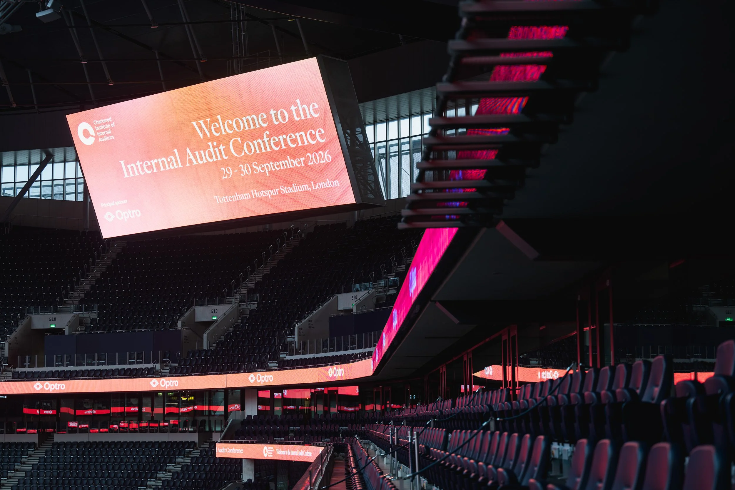 Large stadium screen welcoming delegates to the Internal Audit Conference.