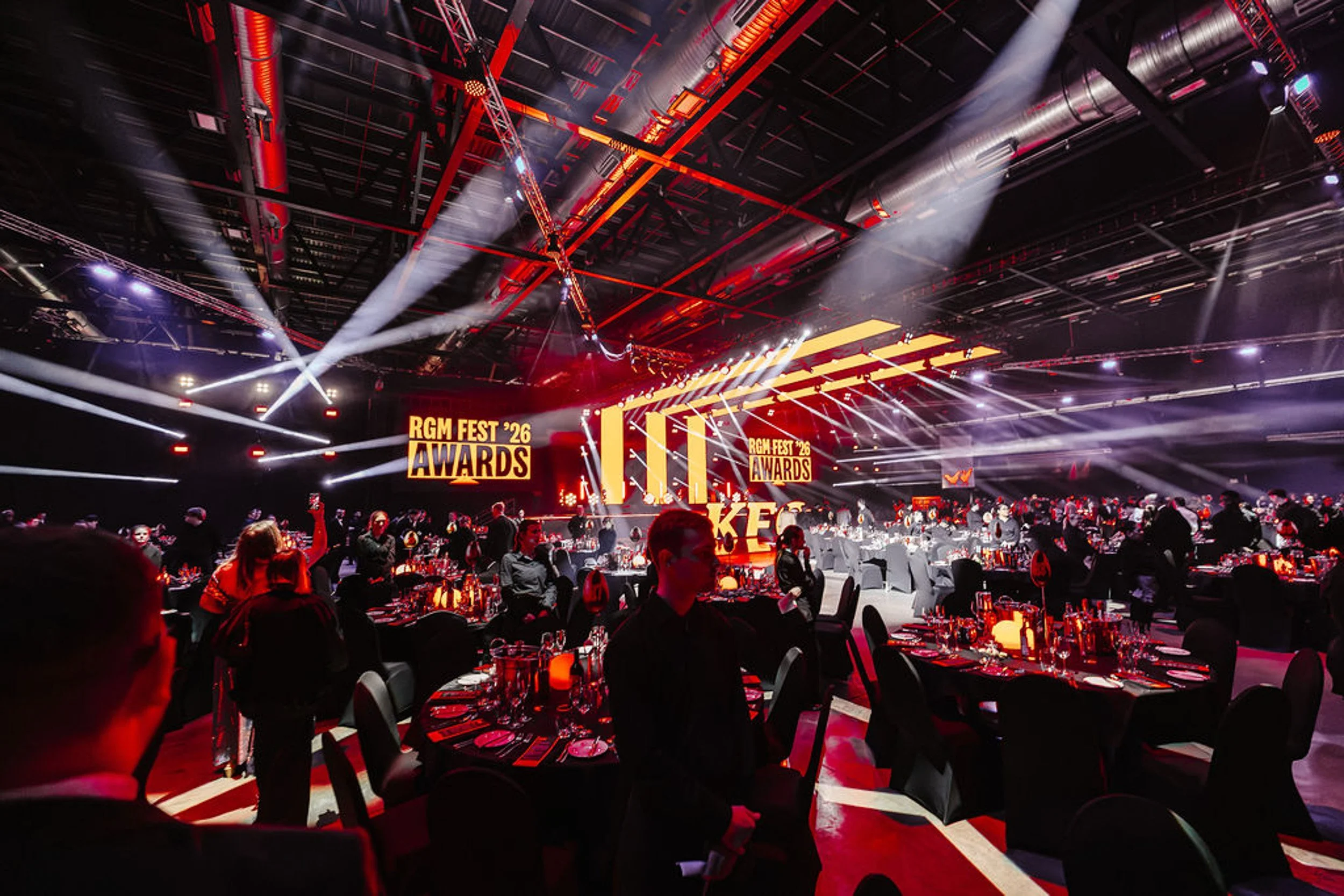 Dinner tables and the illuminated KFC awards stage at Exhibition Centre Liverpool.