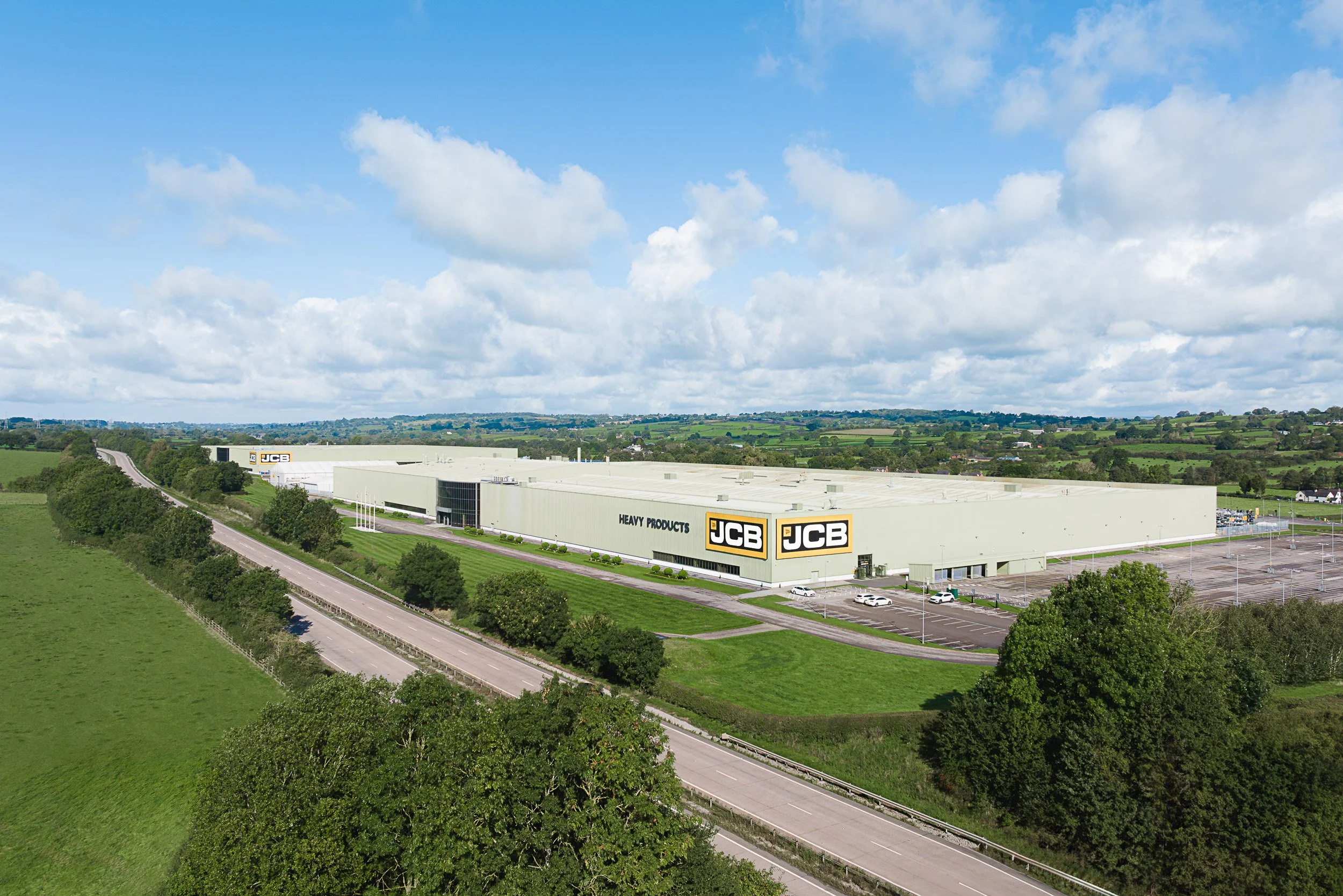 Aerial view of a large industrial facility surrounded by roads and fields.