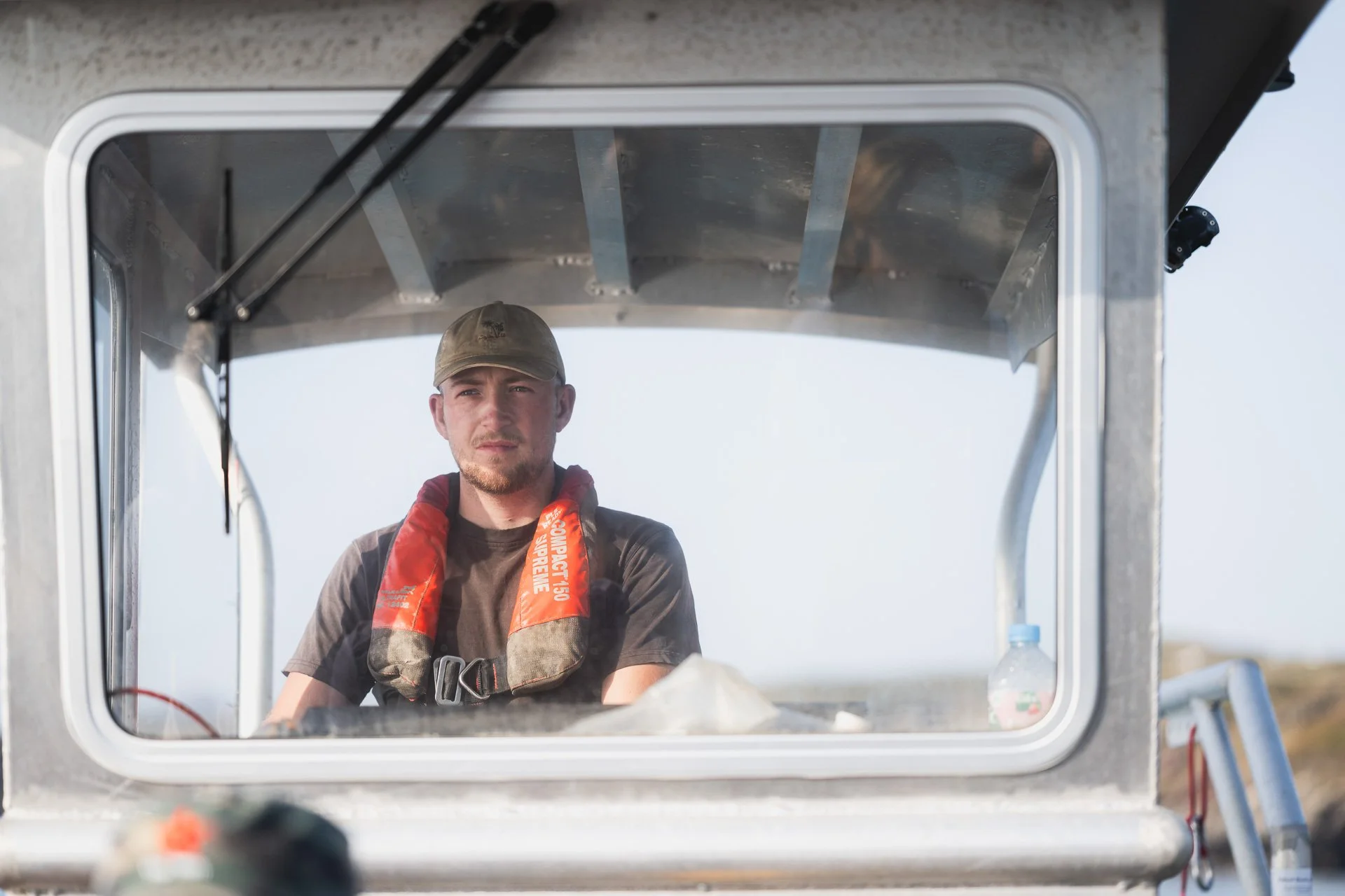 Boat operator seen through the cabin window during the Câr-y-Môr visit.