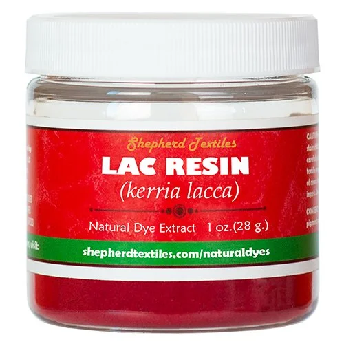 A plastic jar full of red powder labeled "Lac Resin".