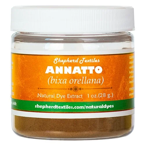 A plastic jar full of brown powder labeled "Annatto".