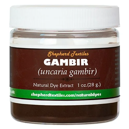 A plastic jar full of brown powder labeled "Gambir".