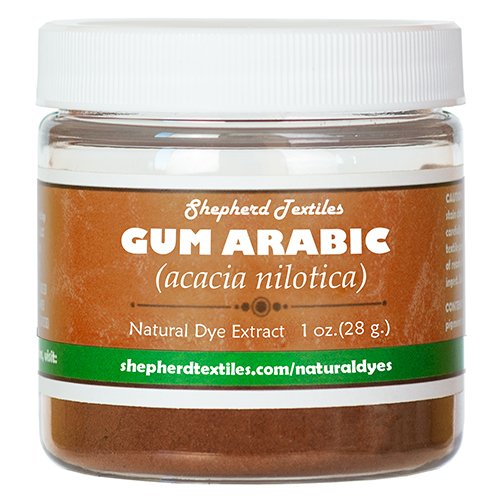A plastic jar full of brown powder labeled "Gum Arabic".