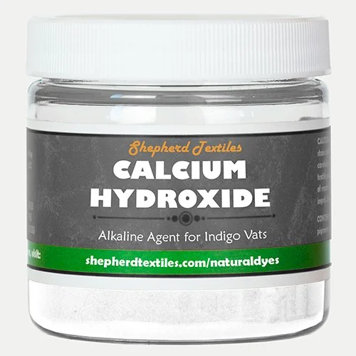 A plastic jar filled with white powder labeled "Calcium Hydroxide."