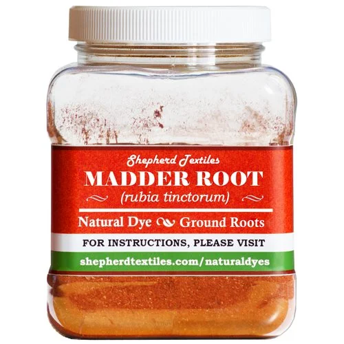 A plastic jar full of red powder with a label reading "Madder Root."