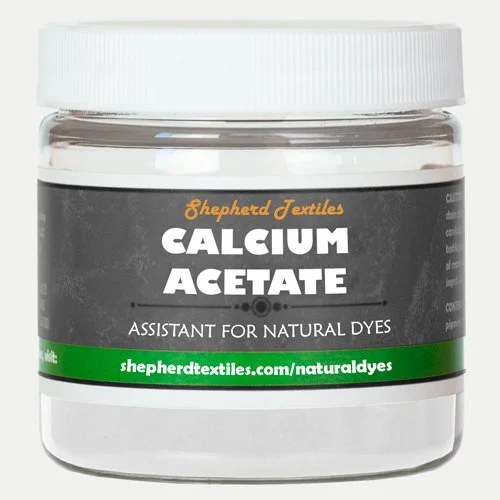 A plastic jar full of white powder labeled "Calcium Acetate."