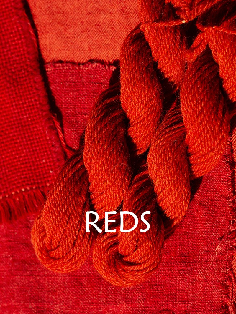 Swatches of fiber and yarn dyed crimson red, with the caption "Reds."