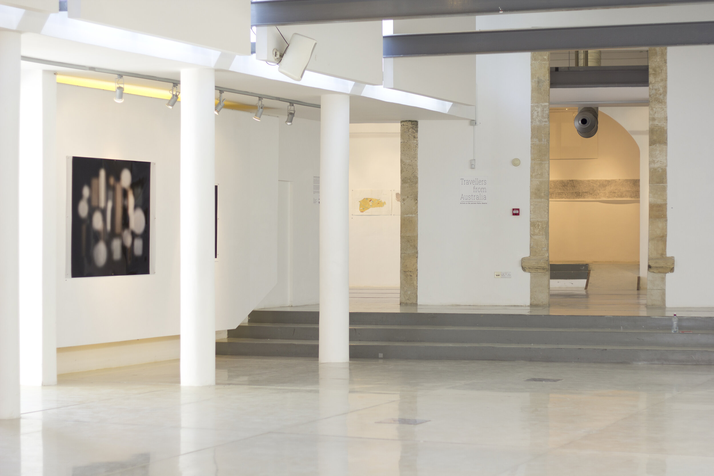  Installation photograph of the group exhibition  Travellers from Australia,  Pailia Ilektriki, Ktima Pafos, Cyprus, 2-15 October 2017. Work by artists (left to right)  Jacky Redgate  and  Bob Miller  visible in the gallery. Photo: Shelley Webster. 