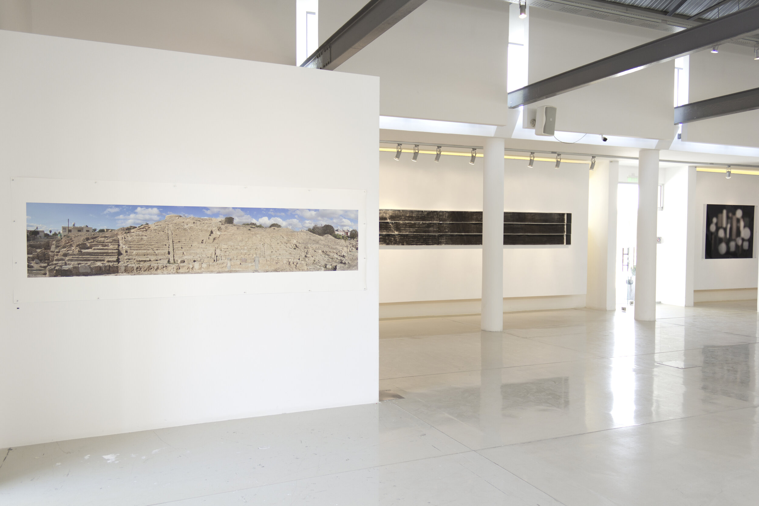  Installation photograph of the group exhibition  Travellers from Australia,  Pailia Ilektriki, Ktima Pafos, Cyprus, 2-15 October 2017. Works by artists (left to right):  Guy Hazell  ,  Lawrence Wallen , and  Jacky Redgate  visible in the gallery. Ph