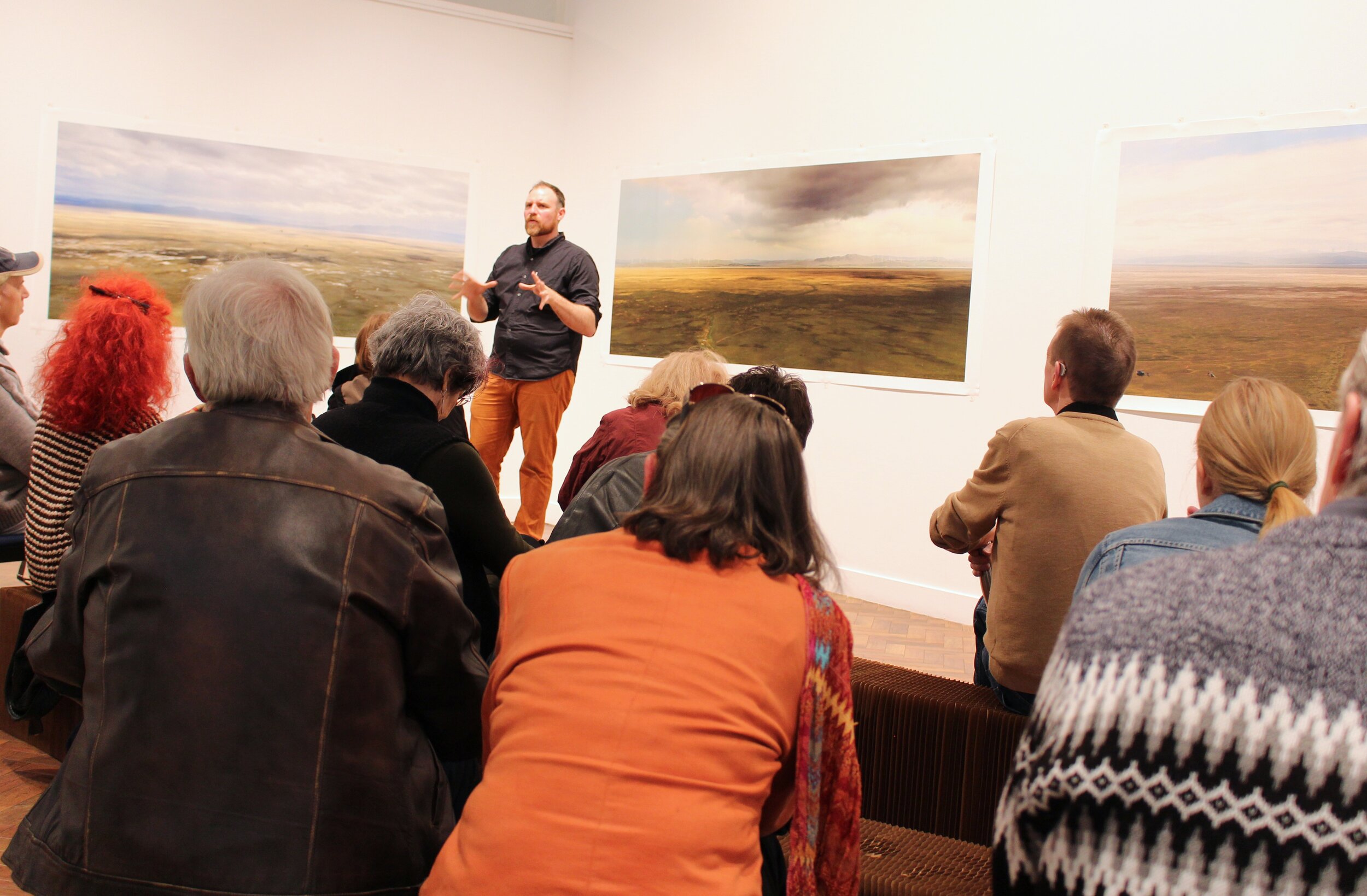  Floor talk by artist  Rowan Conroy  at his solo exhibition  Sighteeing,  held at  Goulburn Regional Art Gallery , 2019.  The works visible in the photo are by the artist. Photo: Courtesy Goulburn Regional Art Gallery. 