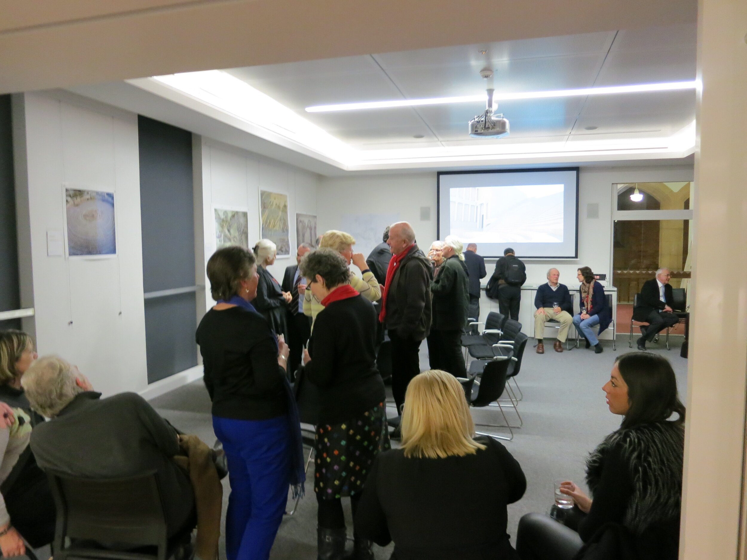  Vew of the opening of  Response to Cyprus,  10 July 2013, hosted by the Australian Archaeological Institute at Athens (AAIA) at the Centre of Classical and Near Eastern Studies of Australia (CCANESA). Works by Derek Kreckler are visible in the backg