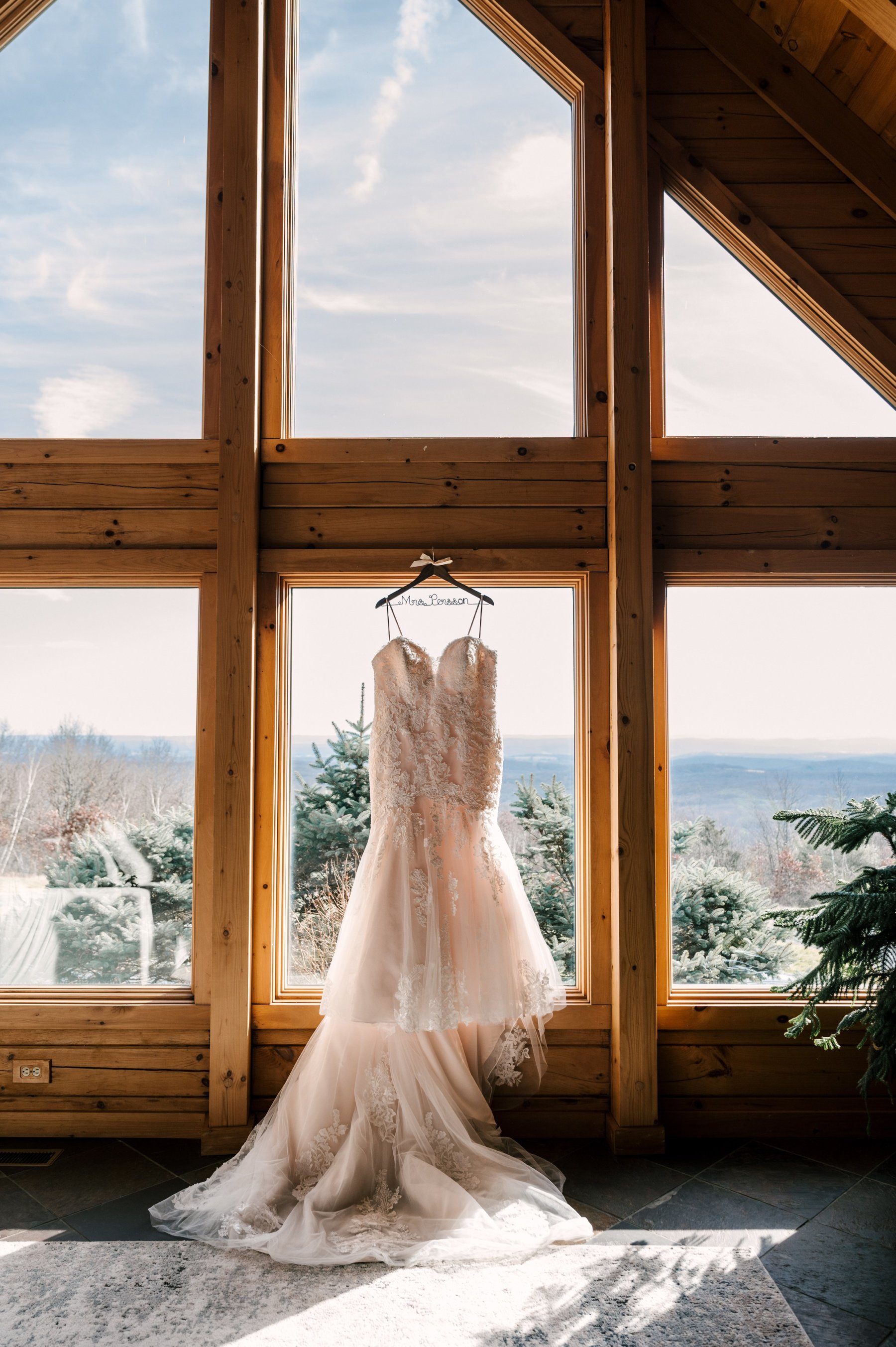 Essense of Australia mermaid wedding dress hanging from a window