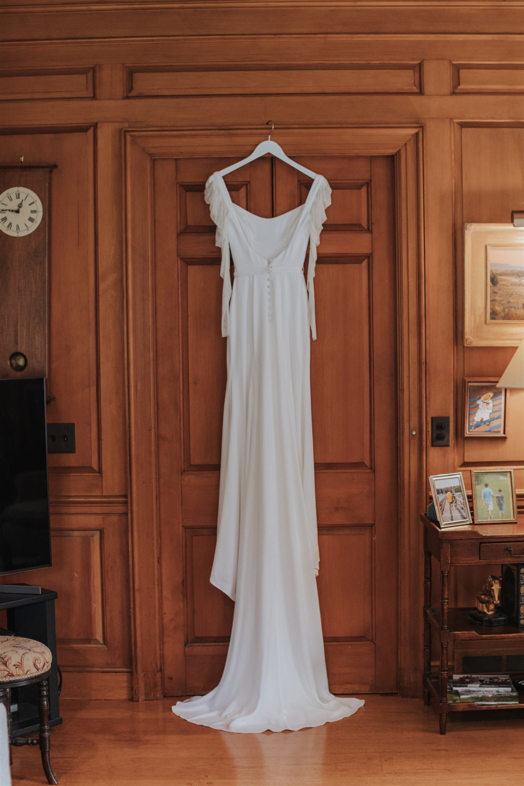 Wedding dress hanging on a doorframe