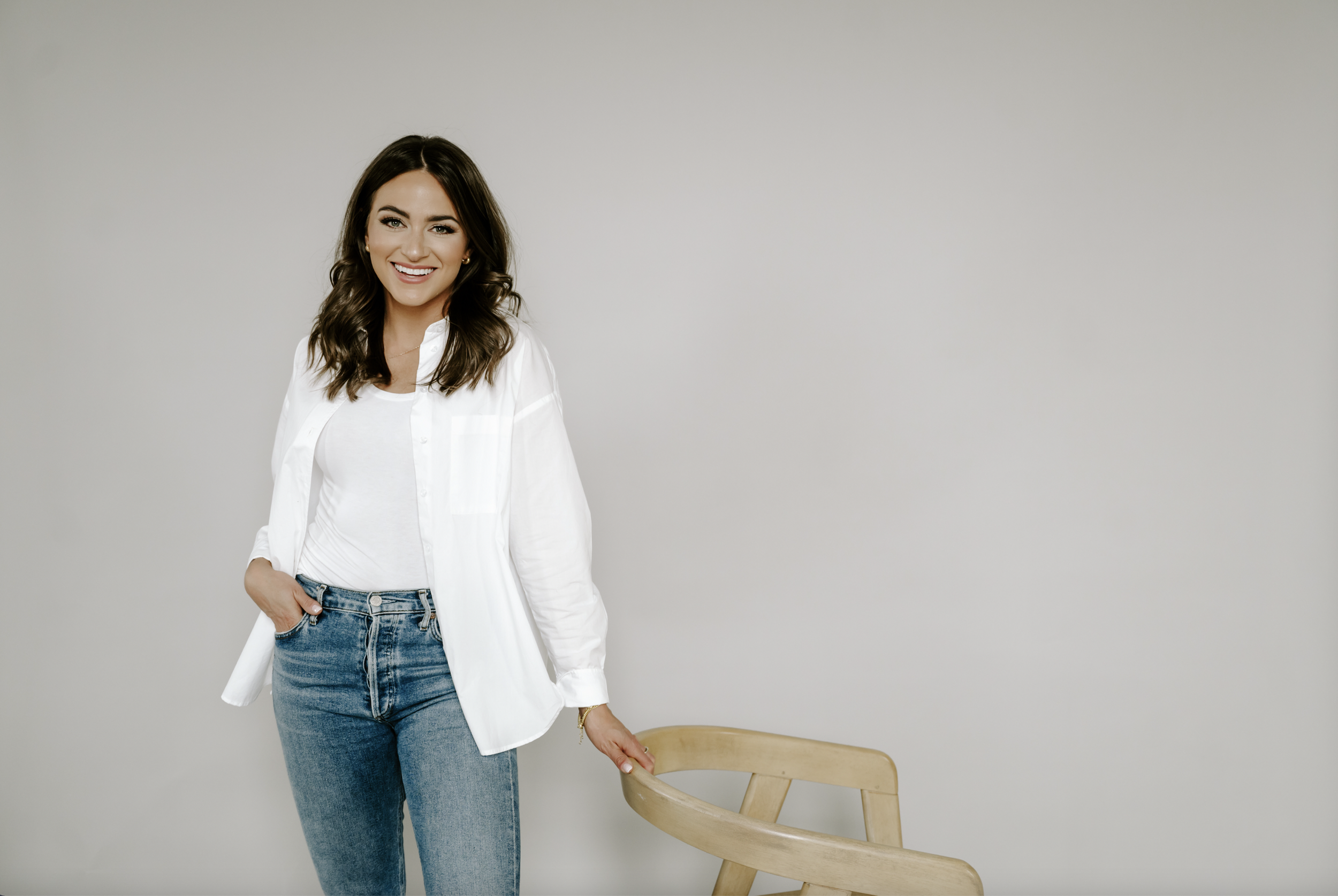 Natalie Dillon, creator of Nattie up North, smiles with arms crossed.