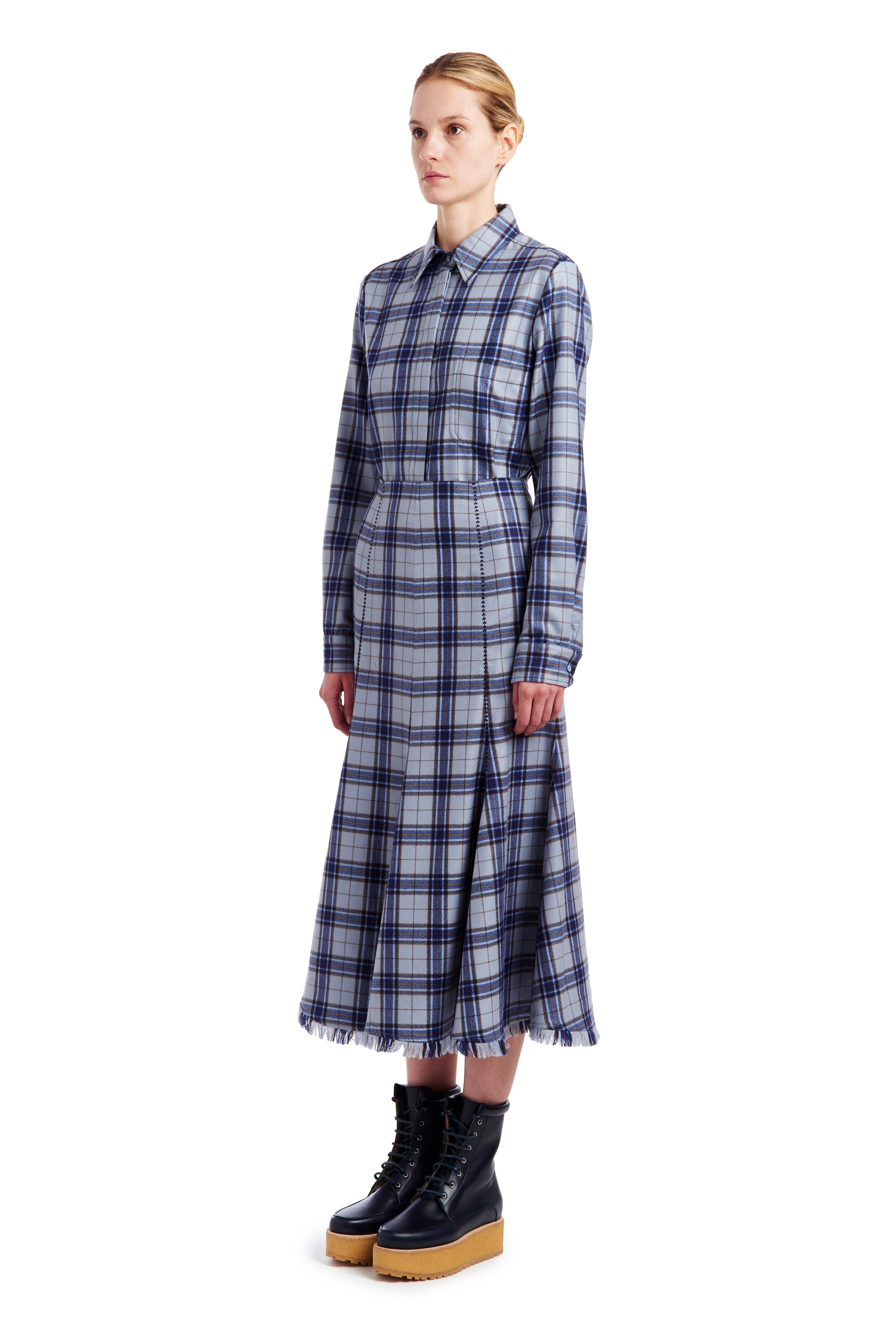 Woman Standing in Blue Plaid Dress