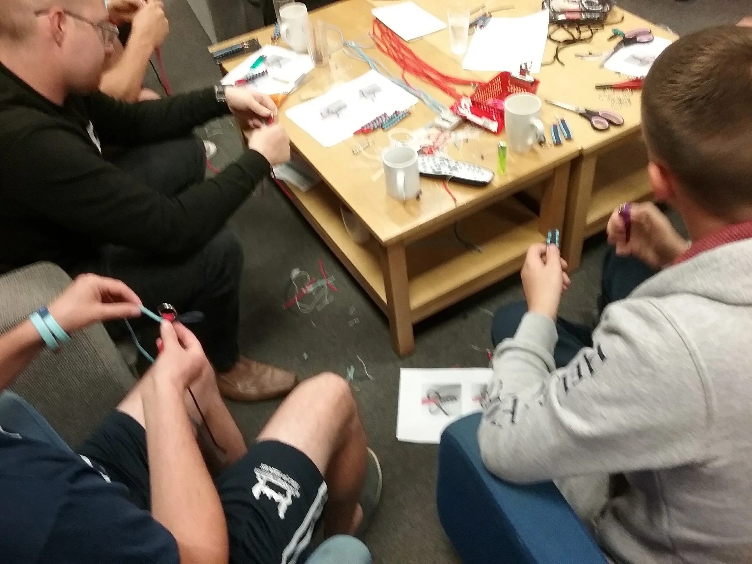 Mae-Kandoo-Help-for-Heroes-workshop-Make-and-Take-veterans-around-coffee-table-crafting