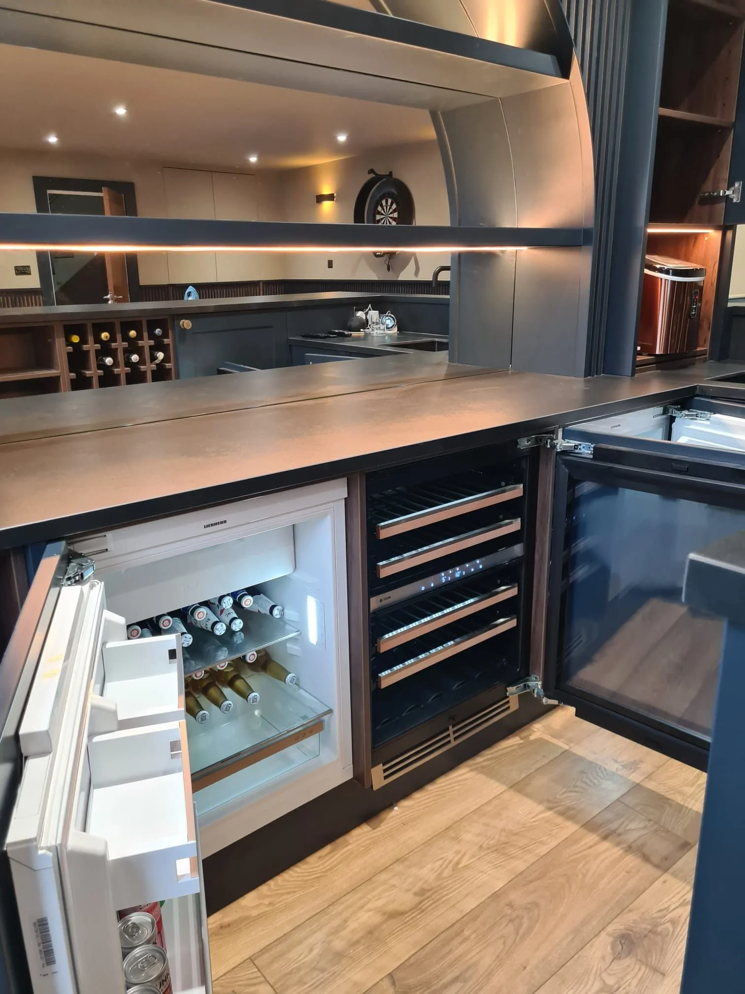 Integrated temperature controlled wine fridge, beer fridge and bin unit.