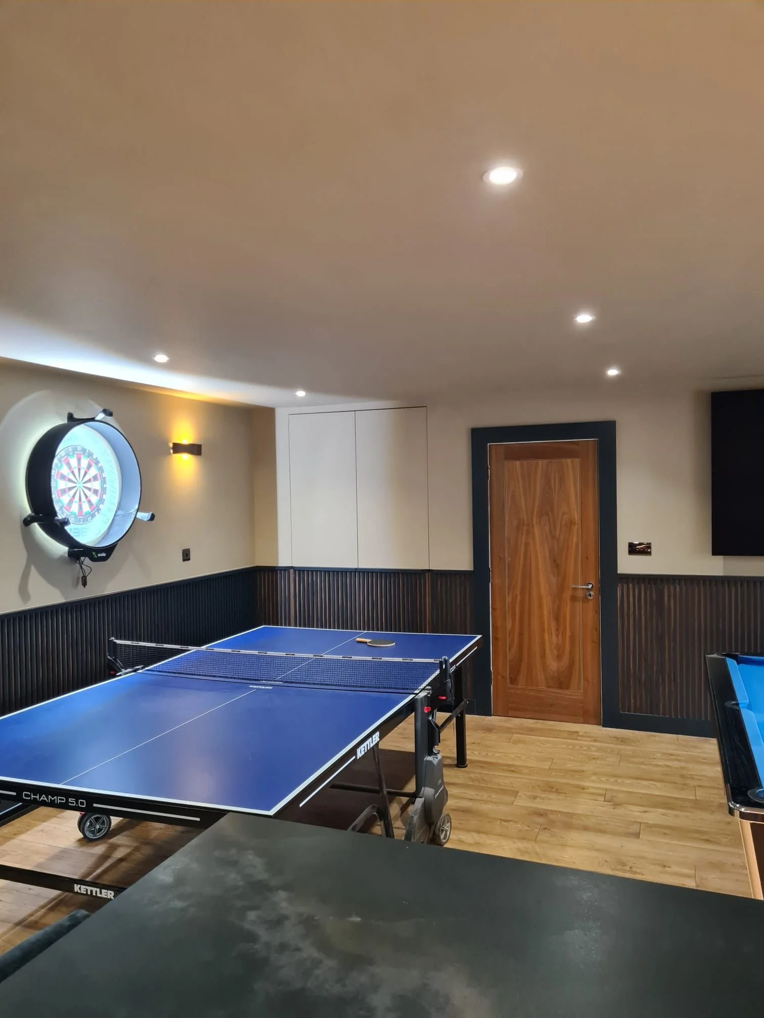 Full room refurbishment with walnut and painted paneling throughout plus interactive darts