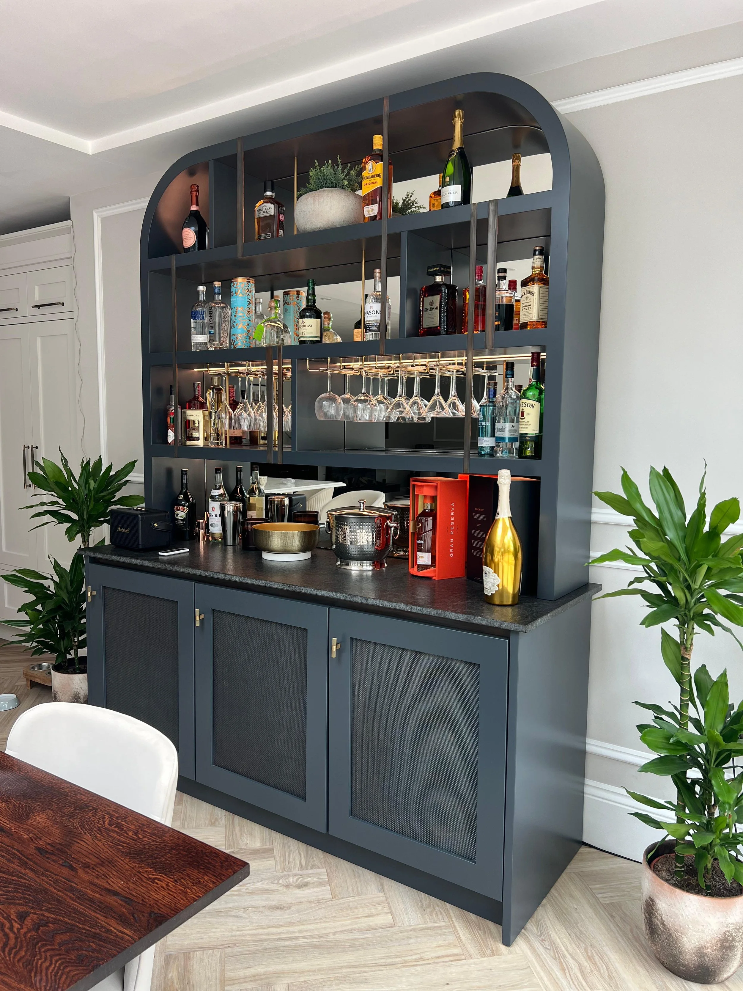 Led Lit, glass hangers , integrated fridge behind middle door, cupboard storage