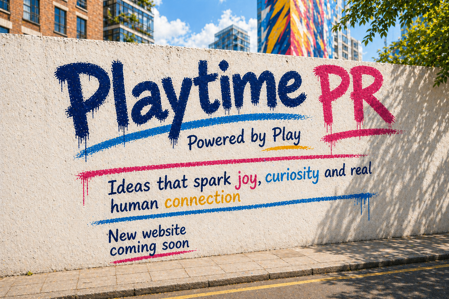 Playtime PR graffiti-style mural with colourful text reading “Ideas that spark joy, curiosity and real human connection”, promoting a UK PR agency for toys, games and consumer brands, with city buildings in the background