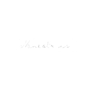 Close-up of a black and white circular logo with the text 'AGNUS DEI' in bold, distressed font.