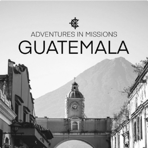 Black and white image of a historic building with a clock tower, mountains in the background, and the text 'Adventures in Missions Guatemala'