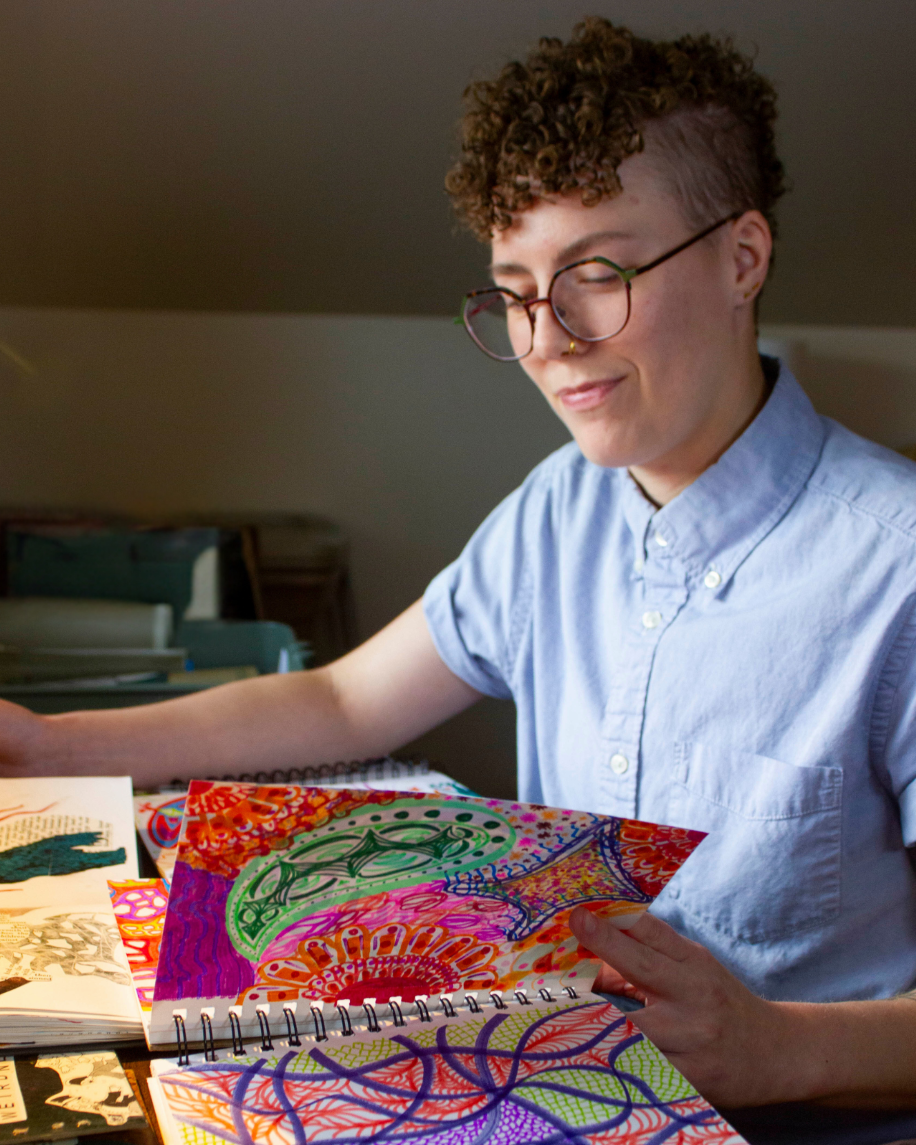 Lore, a white person with short curly hair creates ugly art, battling perfectionism - freelance editor and creativity coach
